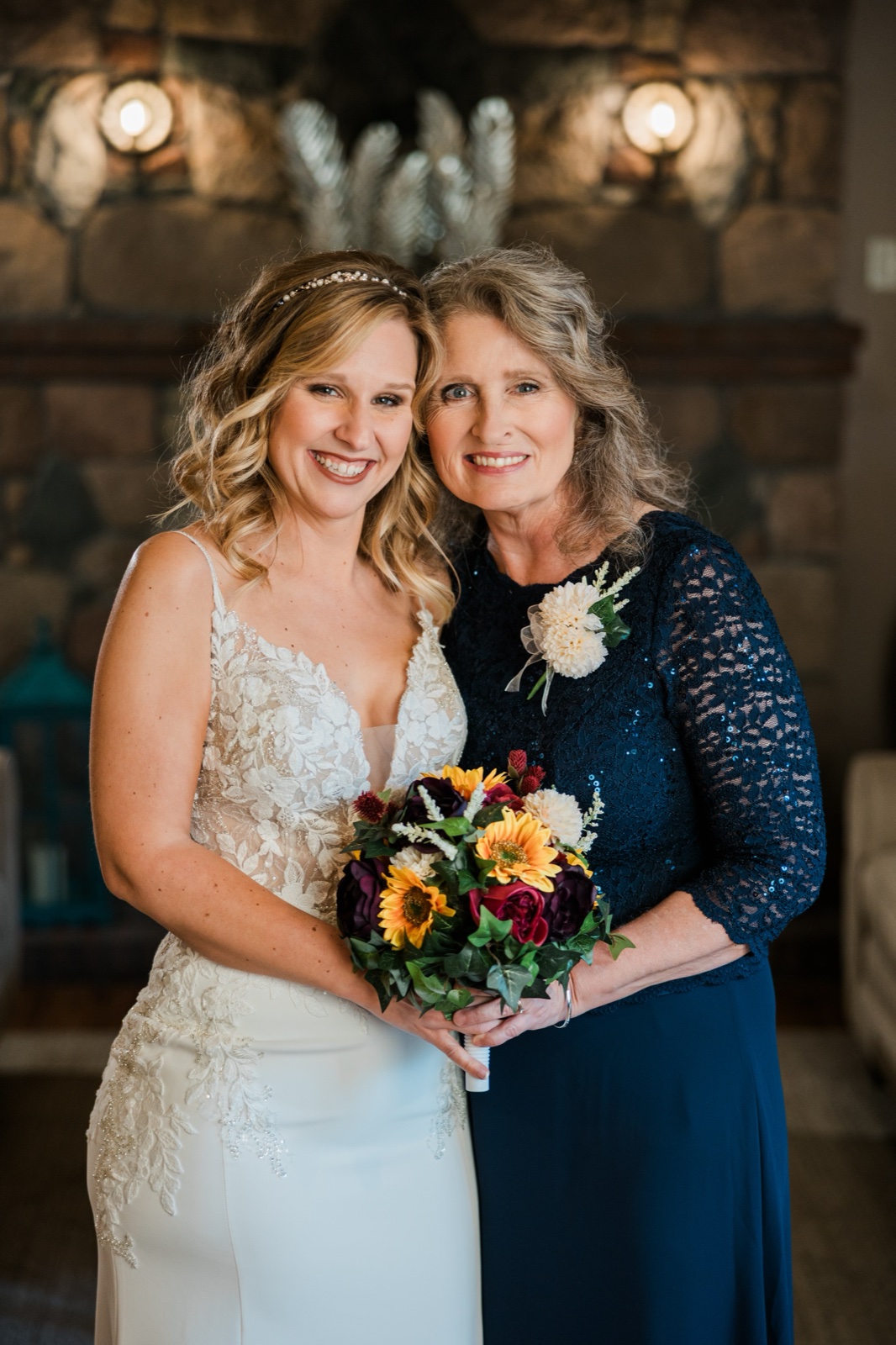 Bride and her mother cheek-to-cheek in front of the stone fireplace — Tim Larsen Photography, Brainerd Lakes MN