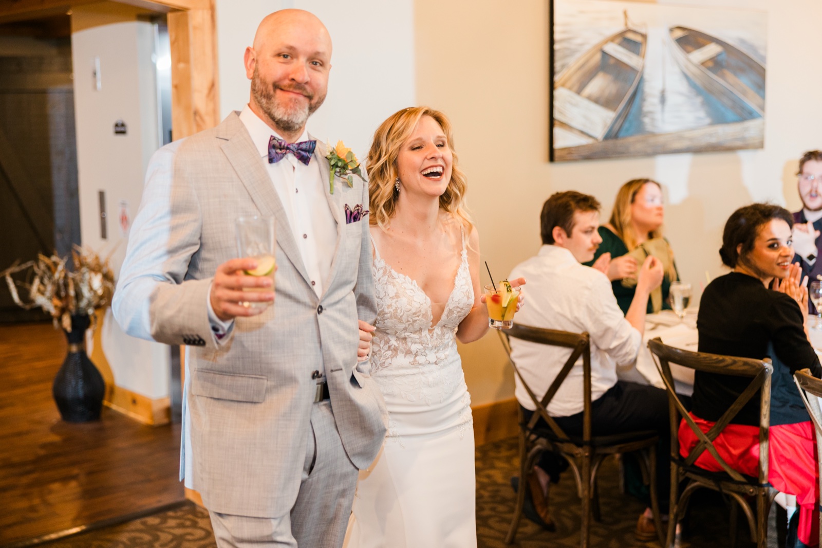 Bride and groom making their reception entrance at Madden's, drinks already in hand — Tim Larsen Photography, Brainerd Lakes MN