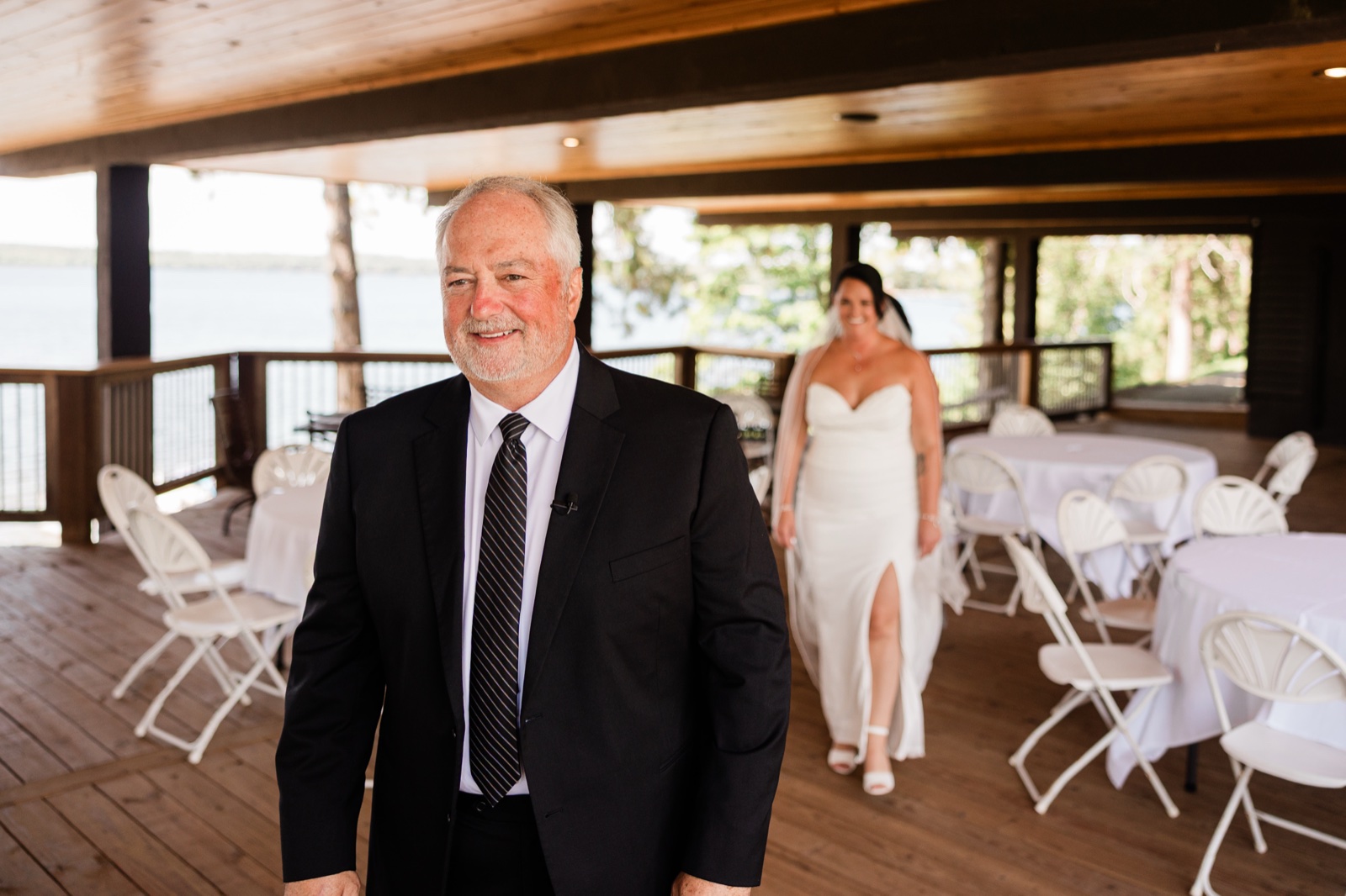 Father-daughter first look on a covered lakeside deck at Madden's, the bride approaching from behind in her veil — Tim Larsen Photography, Brainerd Lakes MN