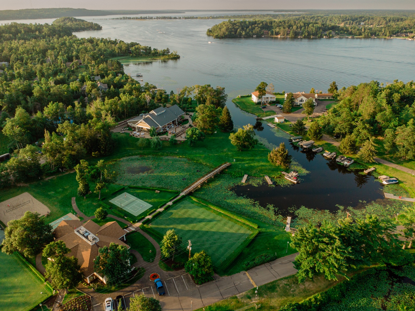Aerial view of Madden's on Gull Lake at sunrise — lakeside buildings, docks with boats, and manicured lawns along the Gull Lake shore — Tim Larsen Photography, Brainerd Lakes MN