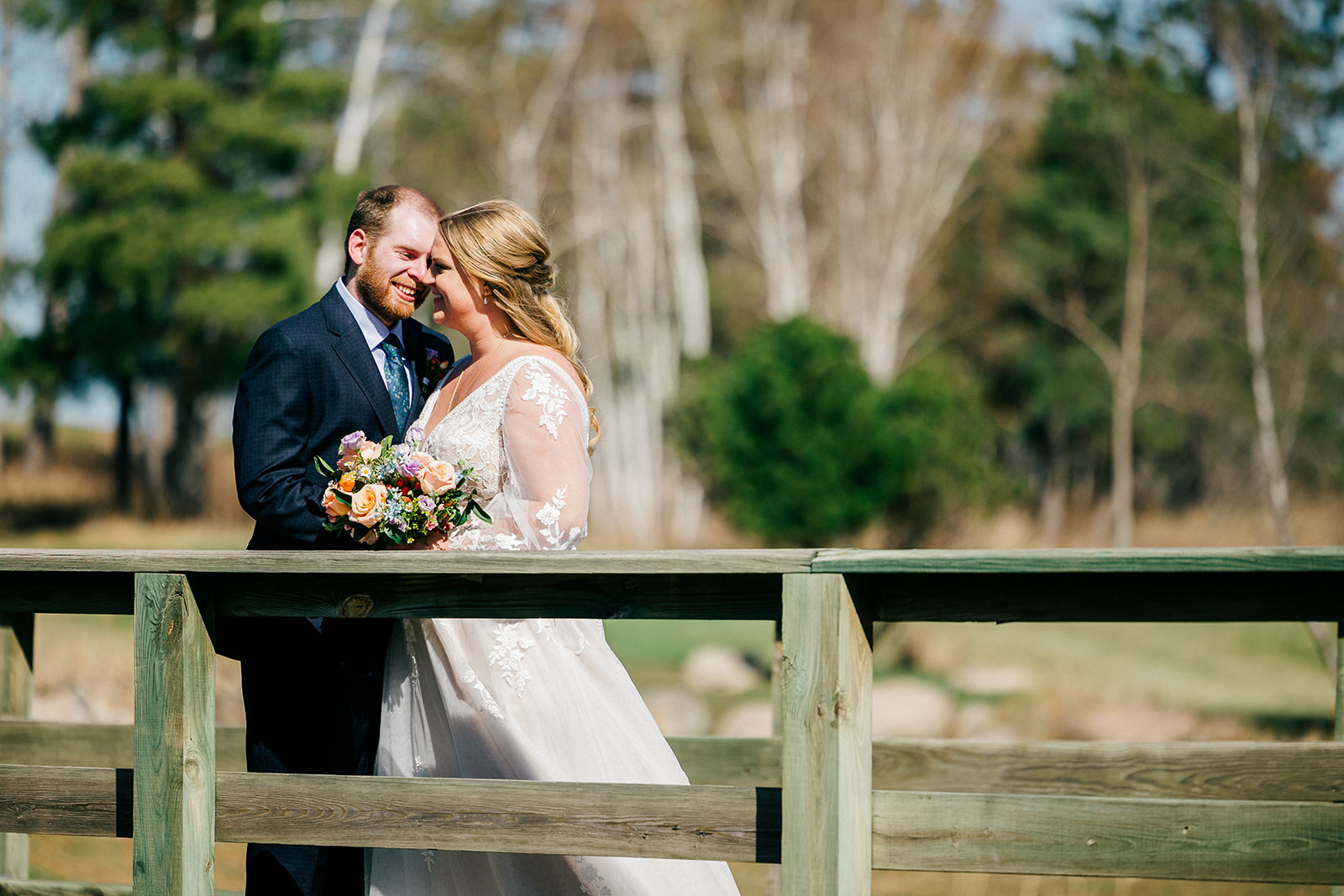 Bride and groom on the wooden bridge walkway at Cragun's Legacy Golf Course, pines in the background — Tim Larsen Photography, Brainerd Lakes MN