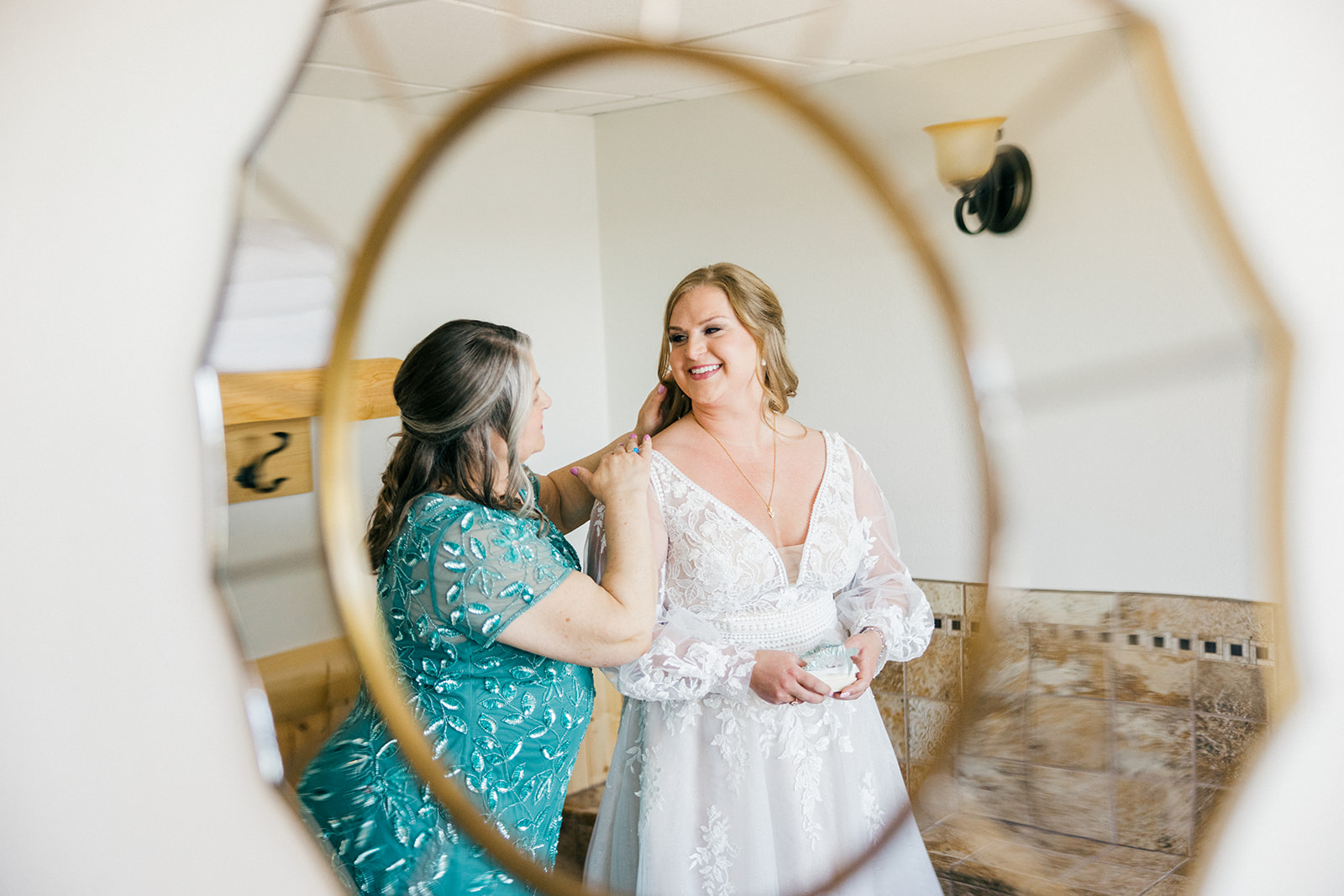Bride's necklace being fastened, reflected in a gold oval mirror during getting ready at Cragun's Legacy — Tim Larsen Photography, Brainerd Lakes MN