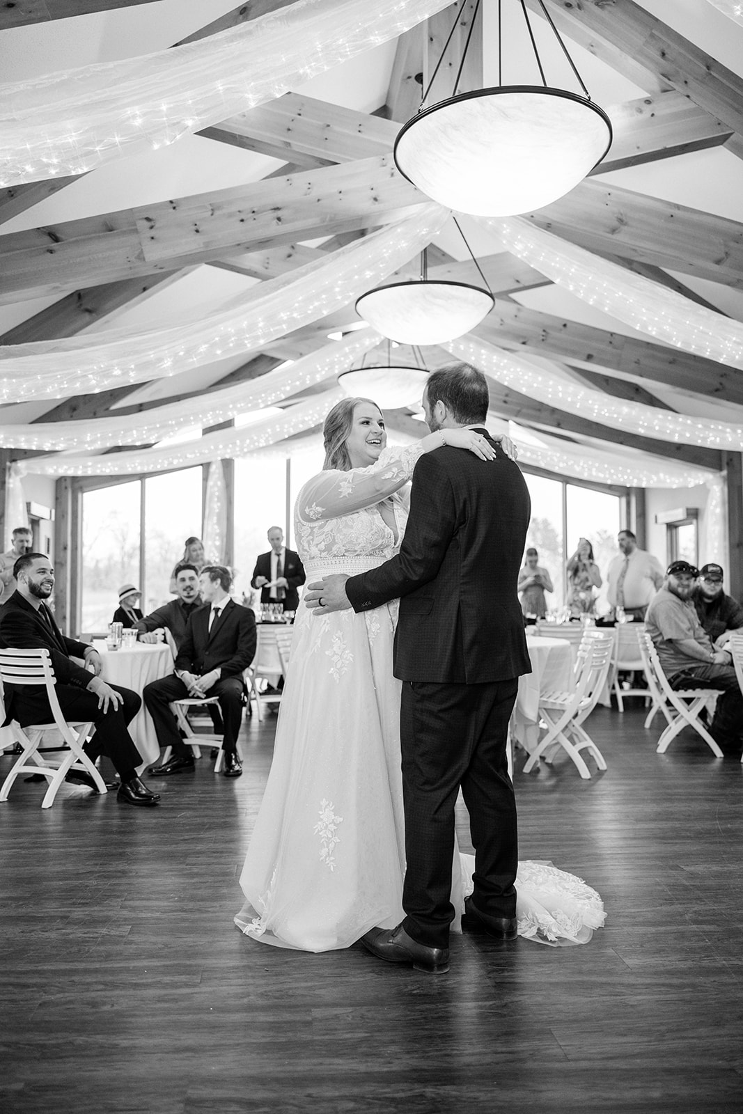 First dance in the Audubon Room at Cragun's Legacy, black and white — couple in the center of the floor, guests watching from tables — Tim Larsen Photography, Brainerd Lakes MN