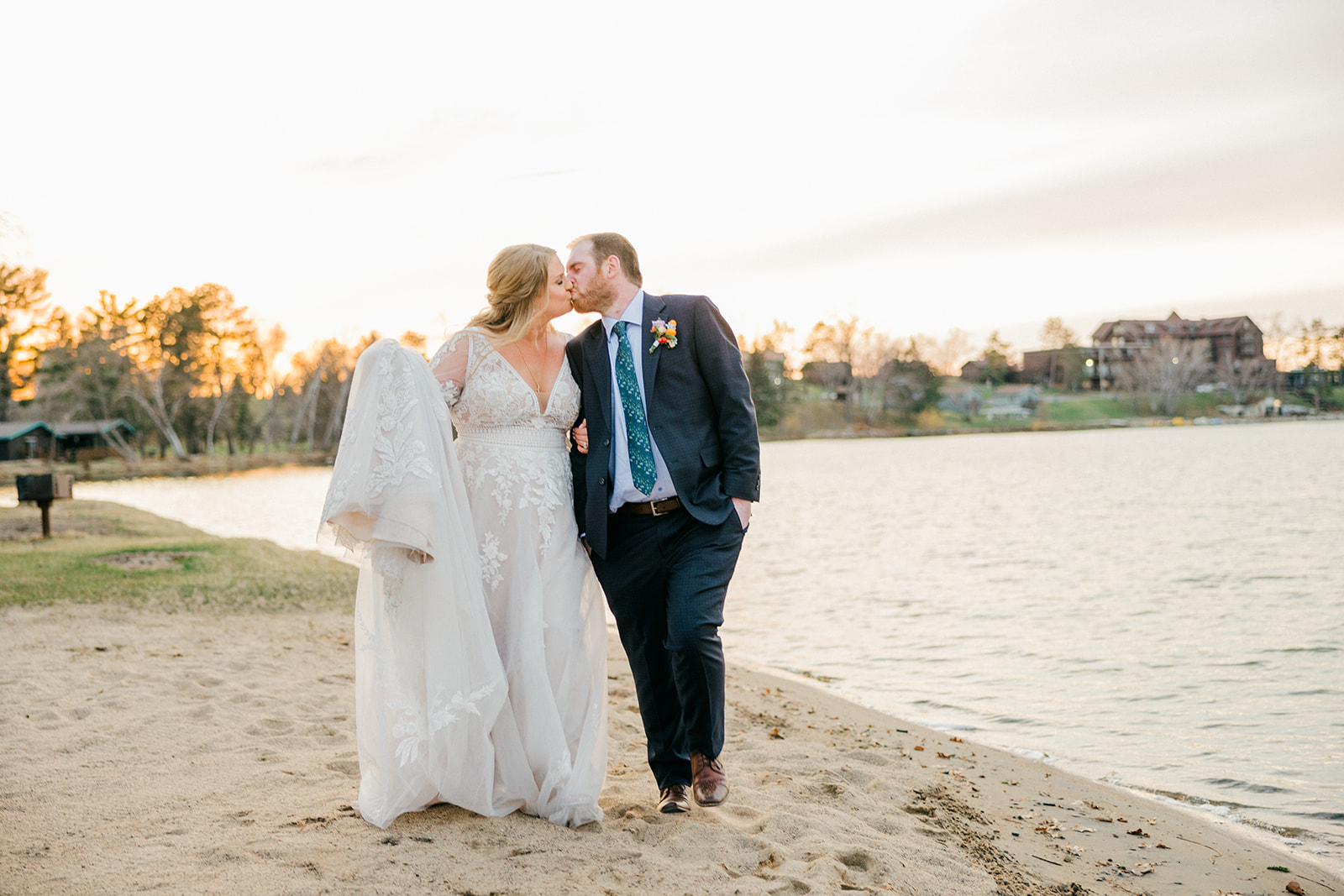 Bride and groom kissing on the Gull Lake beach at Cragun's Legacy Golf Course during golden hour — Tim Larsen Photography, Brainerd Lakes MN