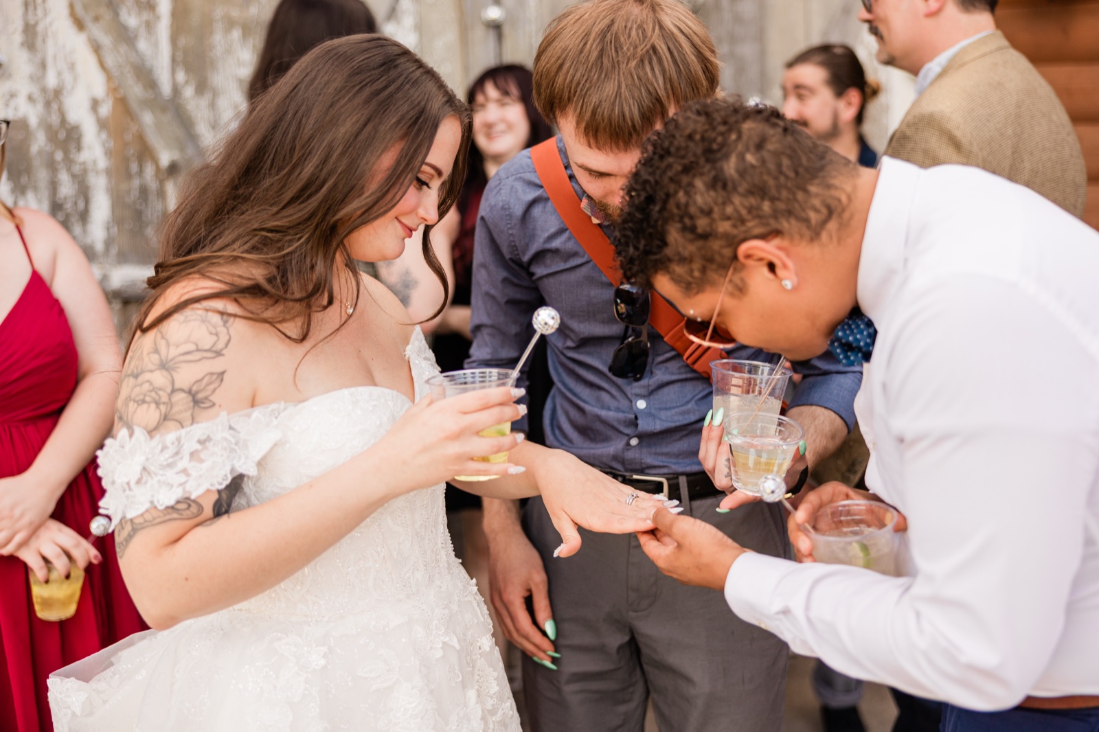 Bride showing her new ring to a guest at cocktail hour