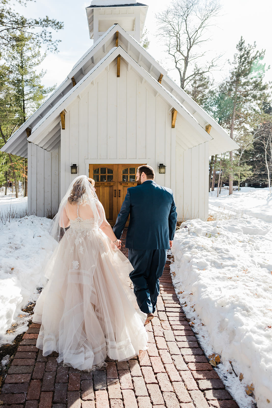 Lauren and Matthew walking toward The Chapel — winter at Grand View Lodge — Tim Larsen Photography, Brainerd Lakes MN
