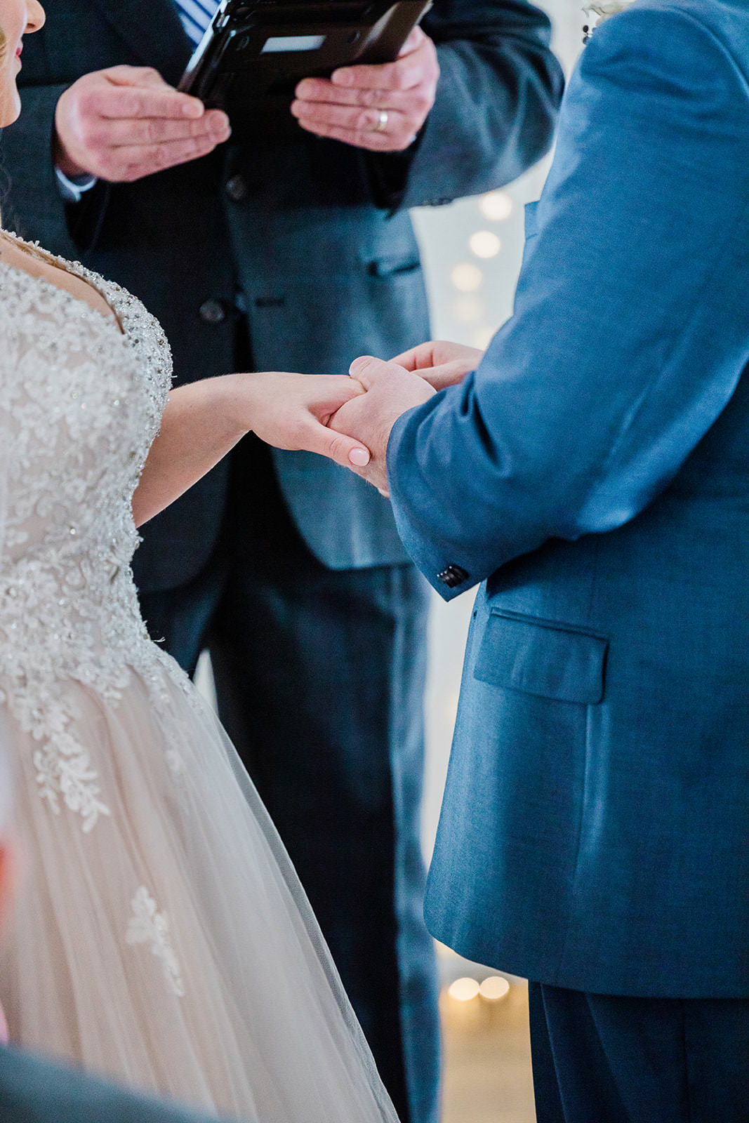 Ring exchange — hands detail at The Chapel ceremony — Tim Larsen Photography, Brainerd Lakes MN