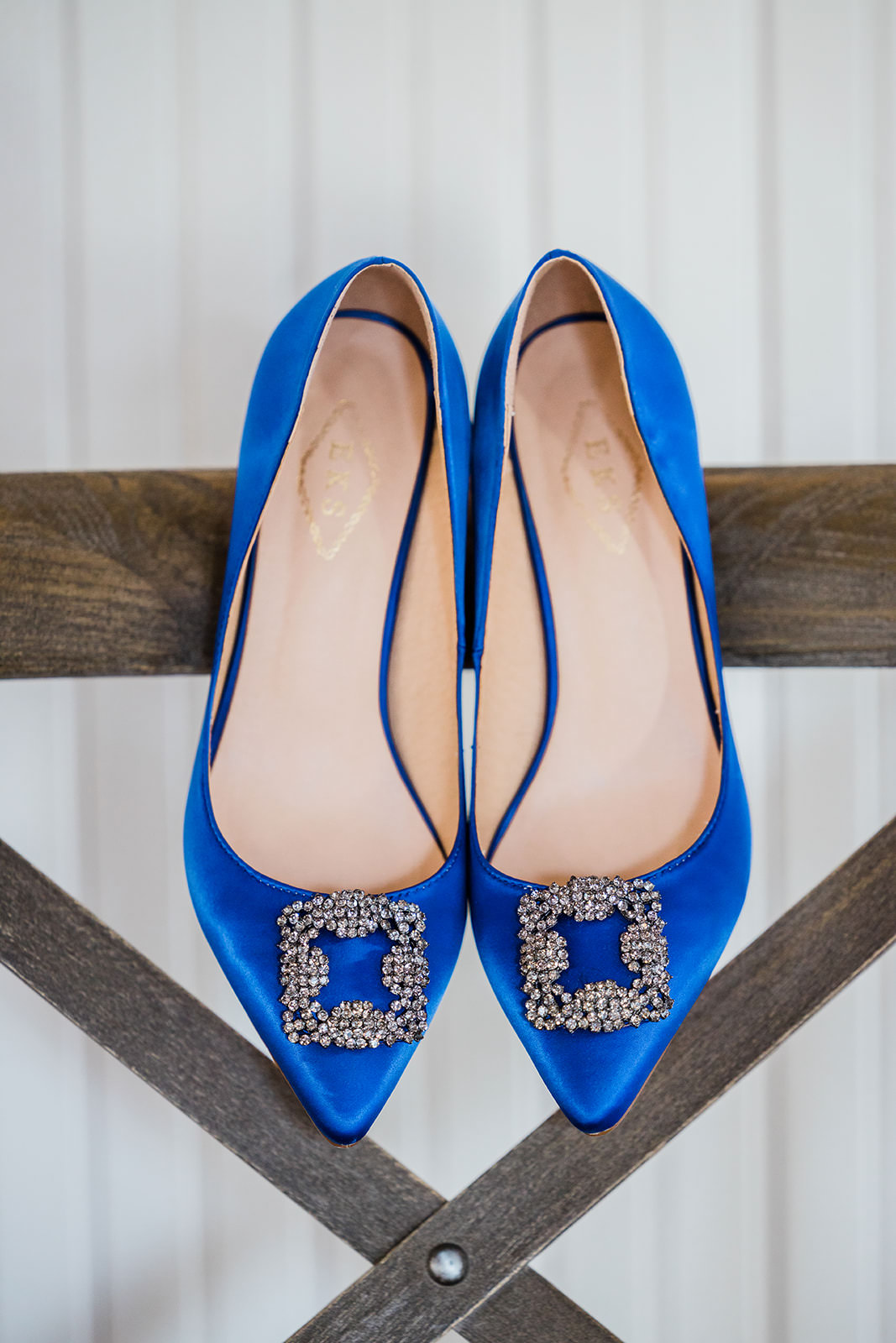 Royal blue satin bridal shoes with crystal buckle on wooden beam — Tim Larsen Photography, Brainerd Lakes MN