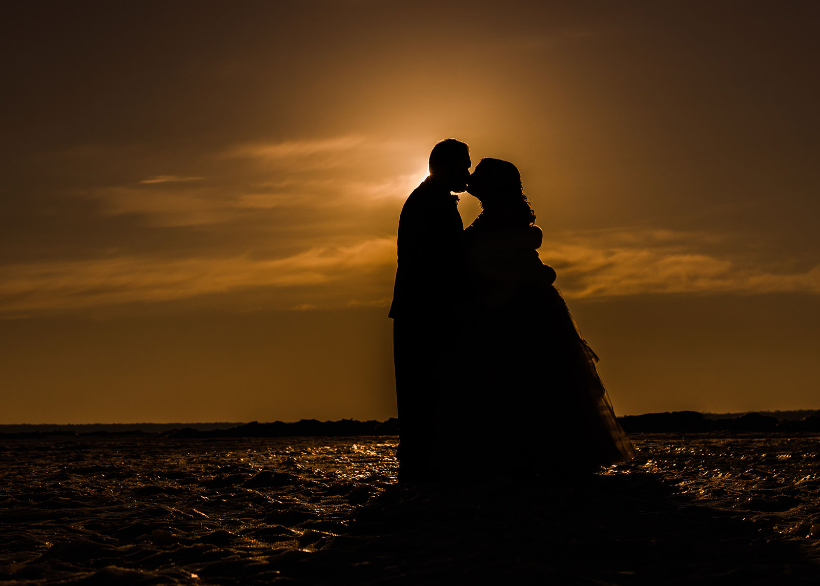 Sunset silhouette kiss on frozen Gull Lake — winter golden hour at Grand View Lodge — Tim Larsen Photography, Brainerd Lakes MN