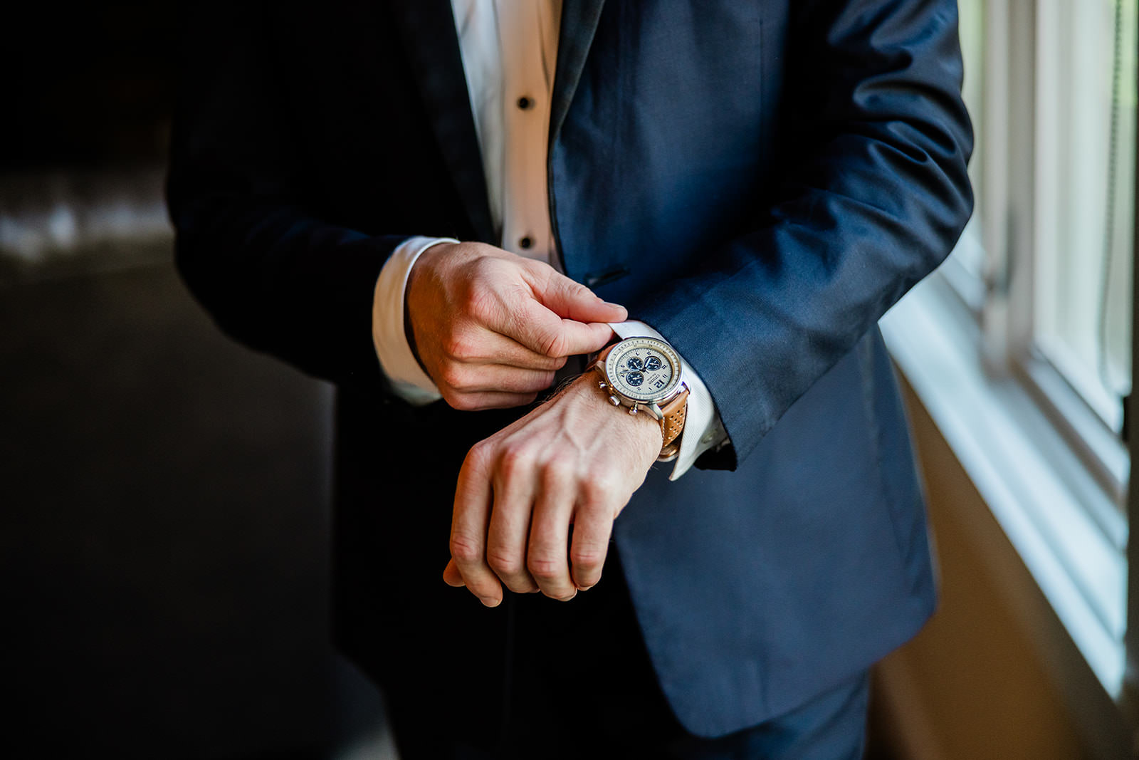 Tyler adjusting his watch — groom details — Tim Larsen Photography, Brainerd Lakes MN