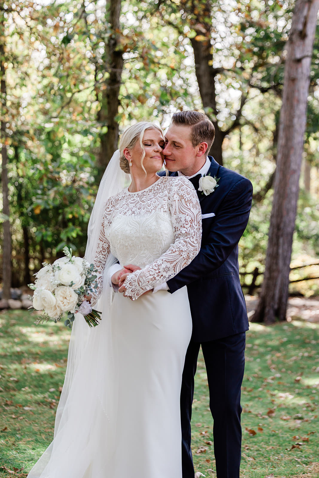 Tyler kissing Maddy — editorial portrait in the Grand View Lodge pines — Tim Larsen Photography, Brainerd Lakes MN