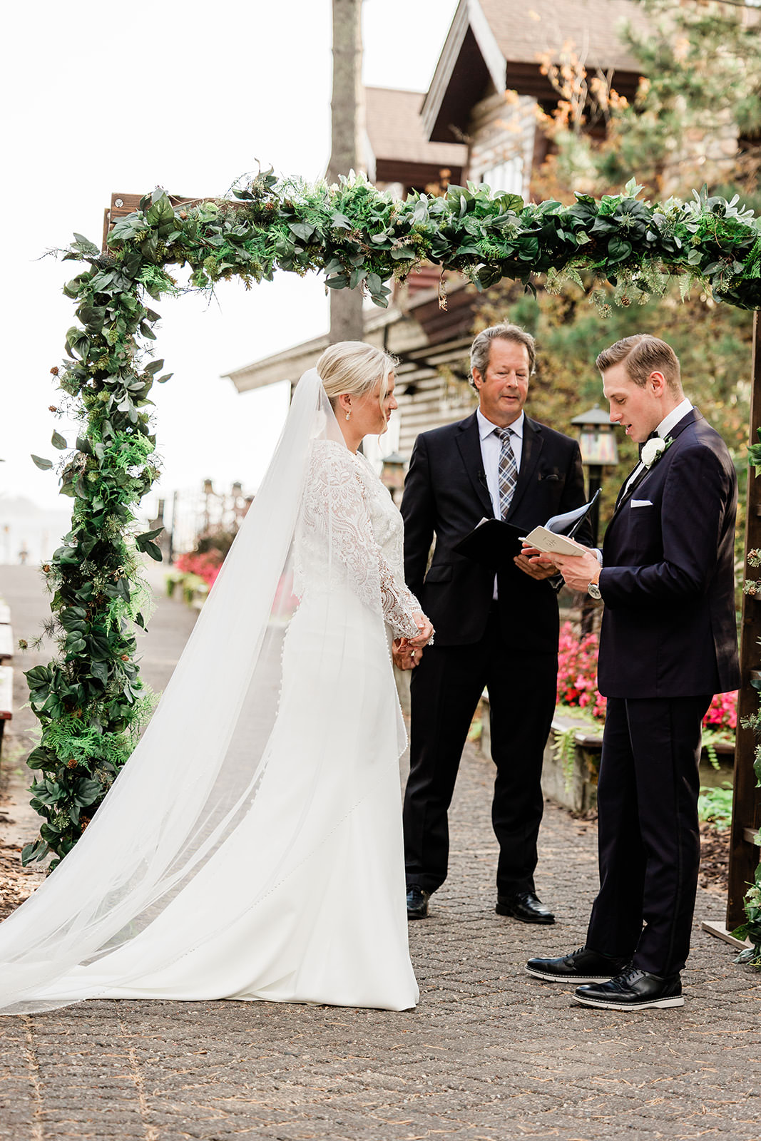 Vows at the altar — greenery arch at Grand View Lodge Grand Staircase — Tim Larsen Photography, Brainerd Lakes MN