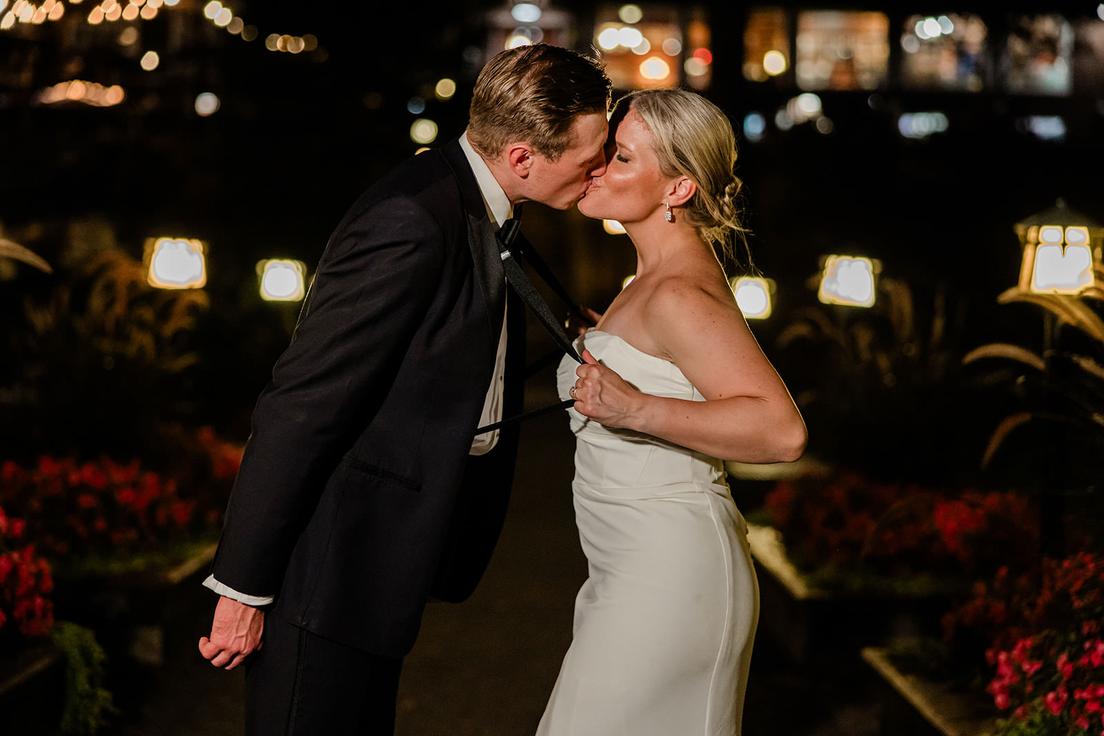 Night kiss on the Grand Staircase — lanterns glowing at Grand View Lodge — Tim Larsen Photography, Brainerd Lakes MN
