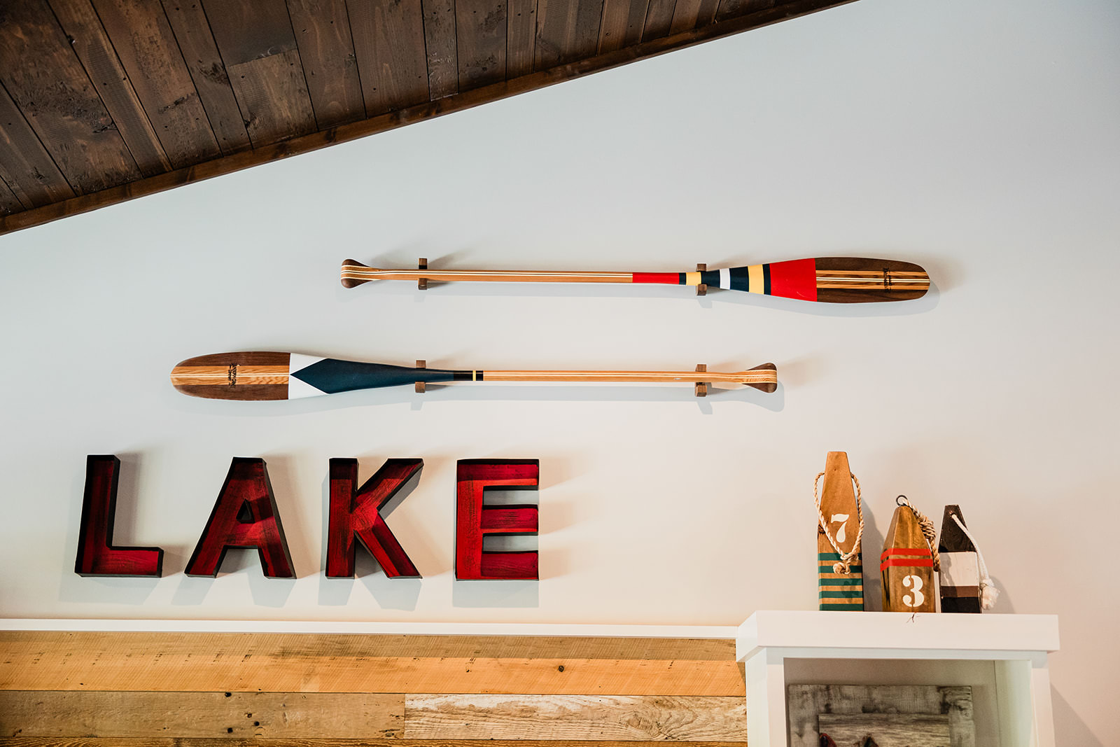 Lake house decor with painted oars and LAKE letters — Tim Larsen Photography, Brainerd Lakes MN