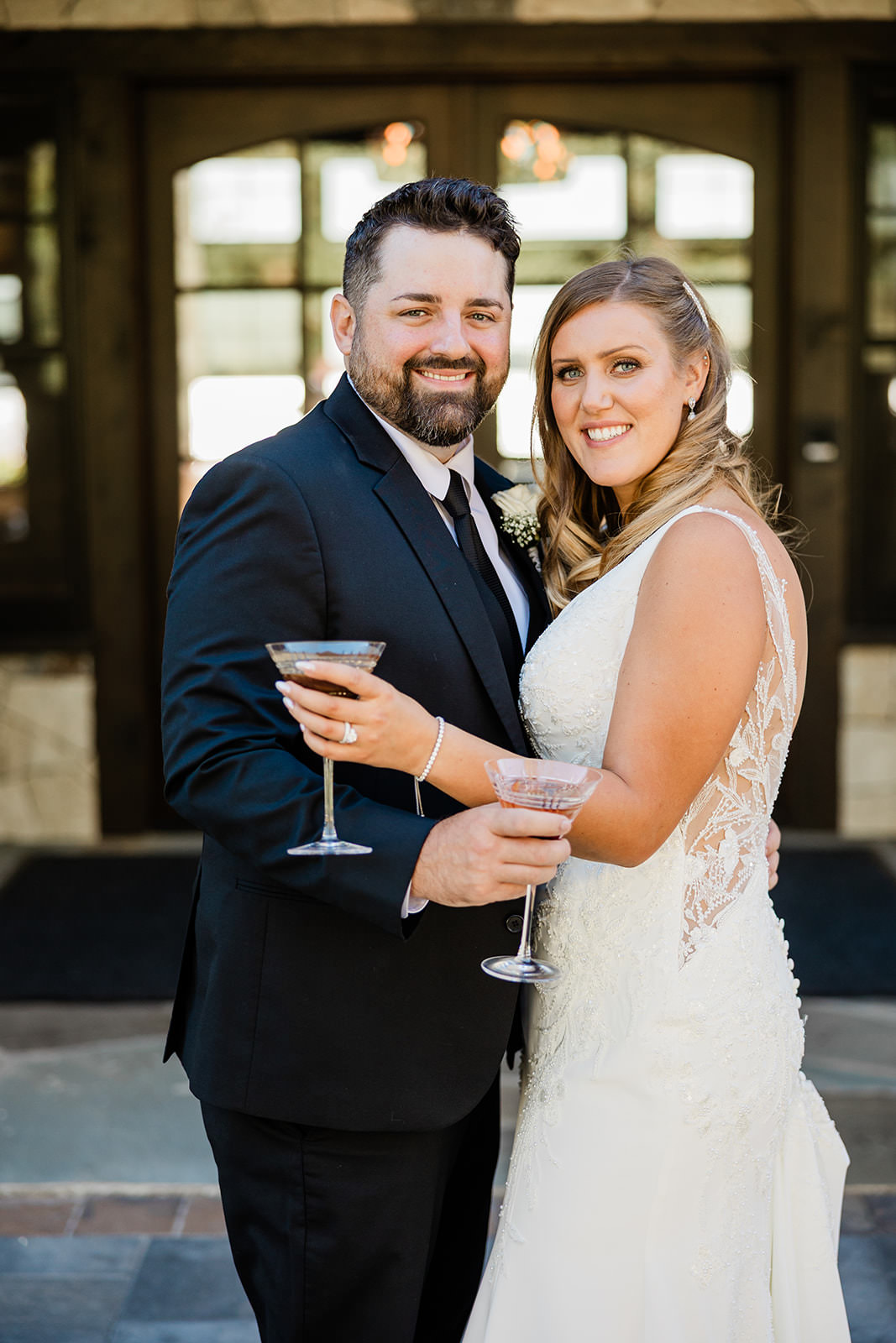 Bride and groom portrait with cocktails in front of The Cove — Crosslake, MN wedding