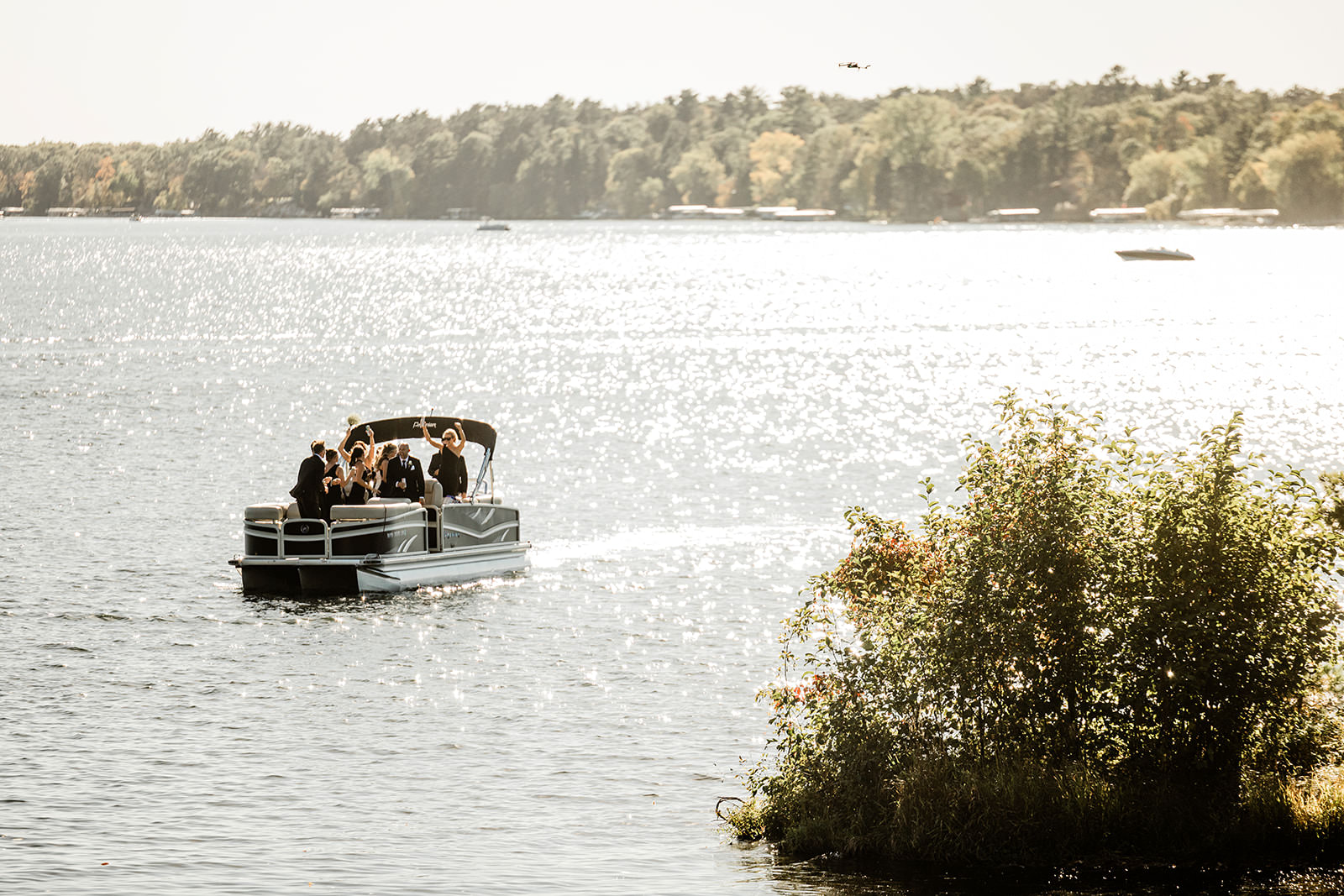 Wedding party arriving by pontoon boat on Whitefish Lake — Tim Larsen Photography, Brainerd Lakes MN
