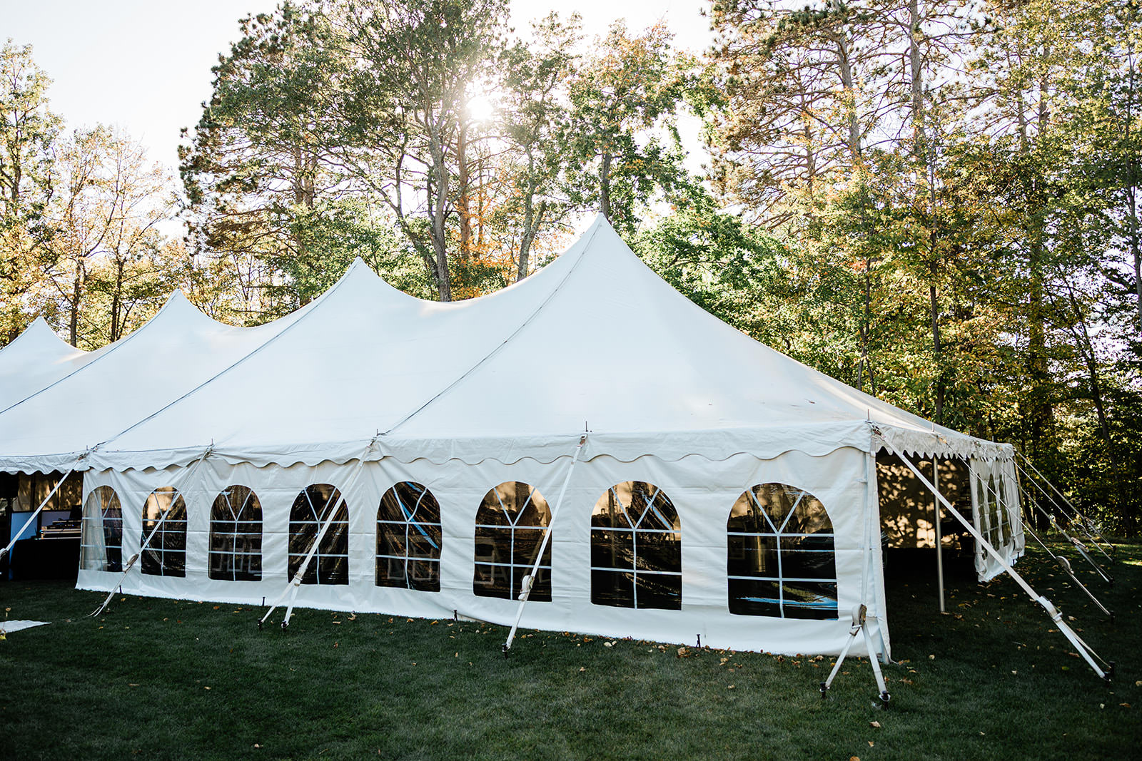 White tent reception setup on the grounds of The Cove — Whitefish Lake wedding