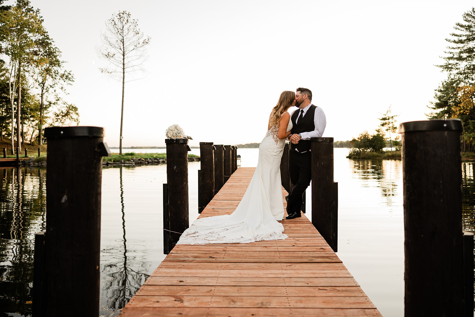 Couple kissing on the dock at golden hour — Tim Larsen Photography, Brainerd Lakes MN