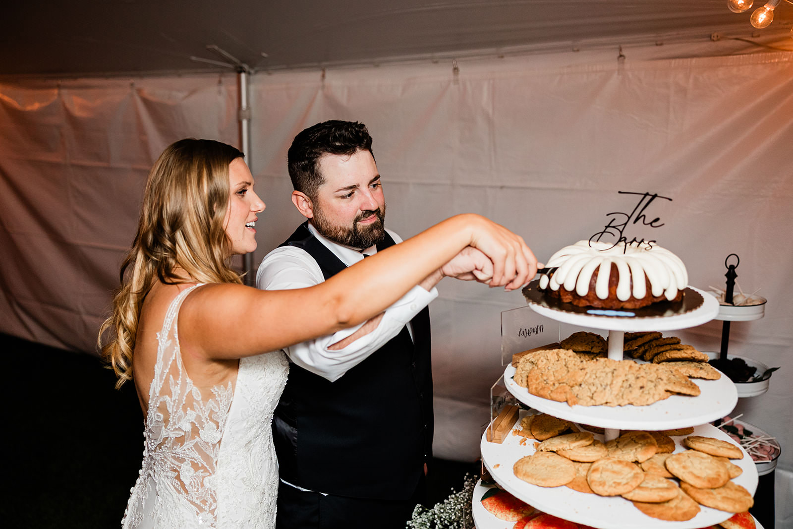 Couple cutting their bundt cake with THE BARRS topper — Tim Larsen Photography, Brainerd Lakes MN