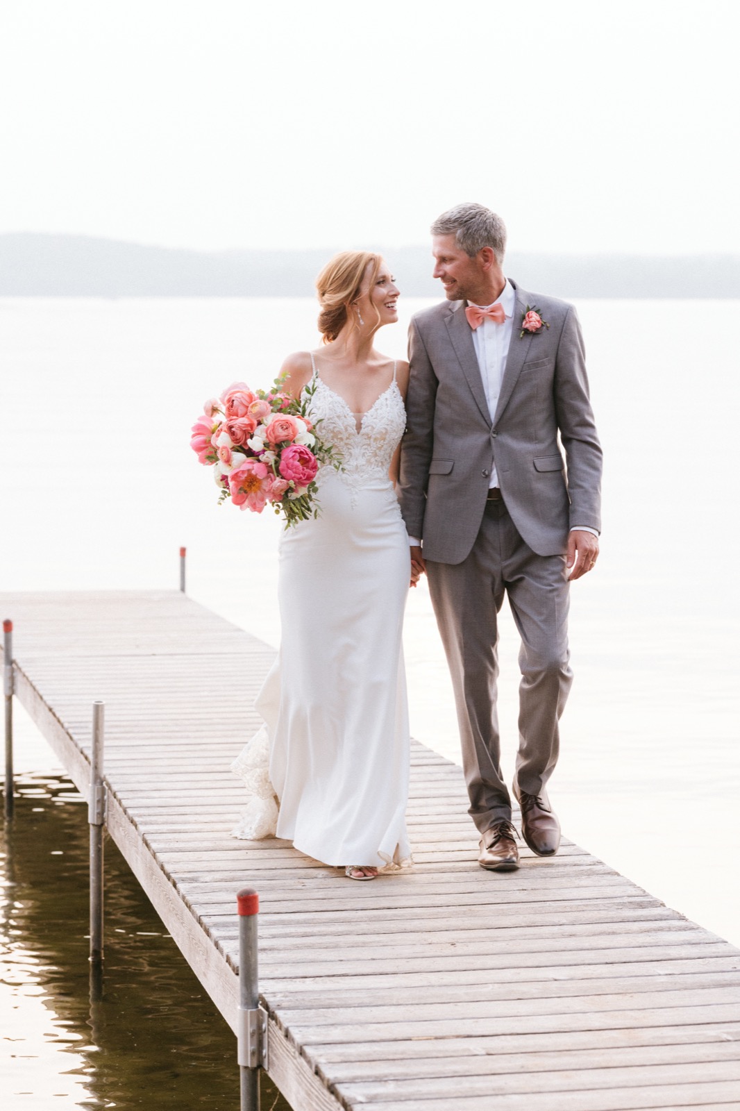 Melissa and Kody centered on a weathered Madden's dock, Gull Lake stretching to the horizon behind them — Tim Larsen Photography, Brainerd Lakes MN