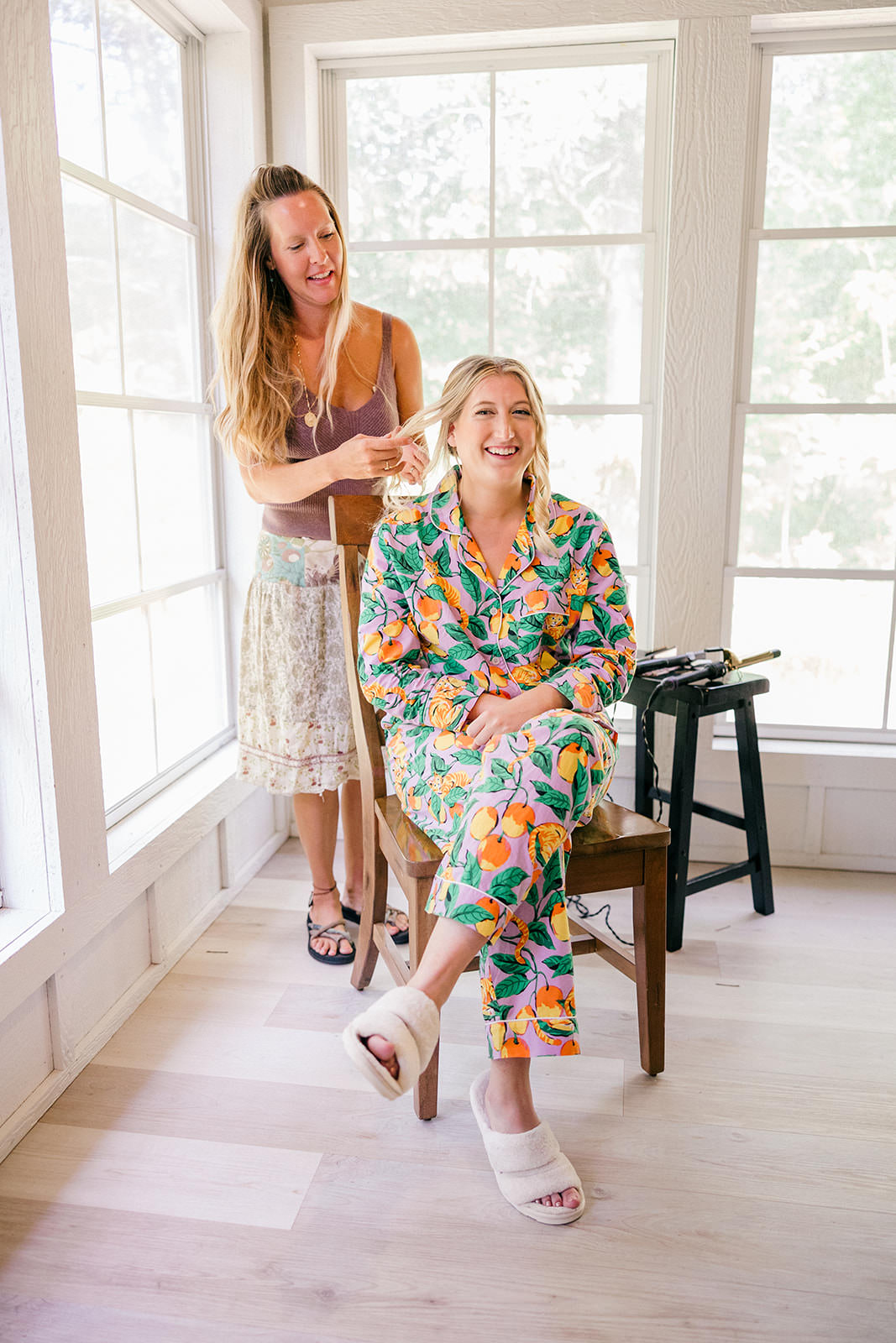 Bride getting her hair done in a floral robe — getting ready at Grand View Lodge — Tim Larsen Photography, Brainerd Lakes MN