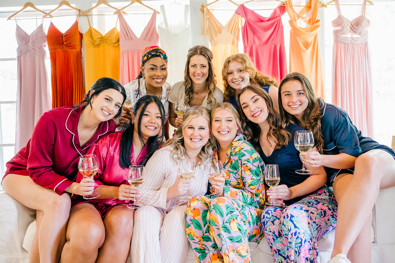 Bride and bridesmaids gathered on a couch with wine — Grand View Lodge suite — Tim Larsen Photography, Brainerd Lakes MN