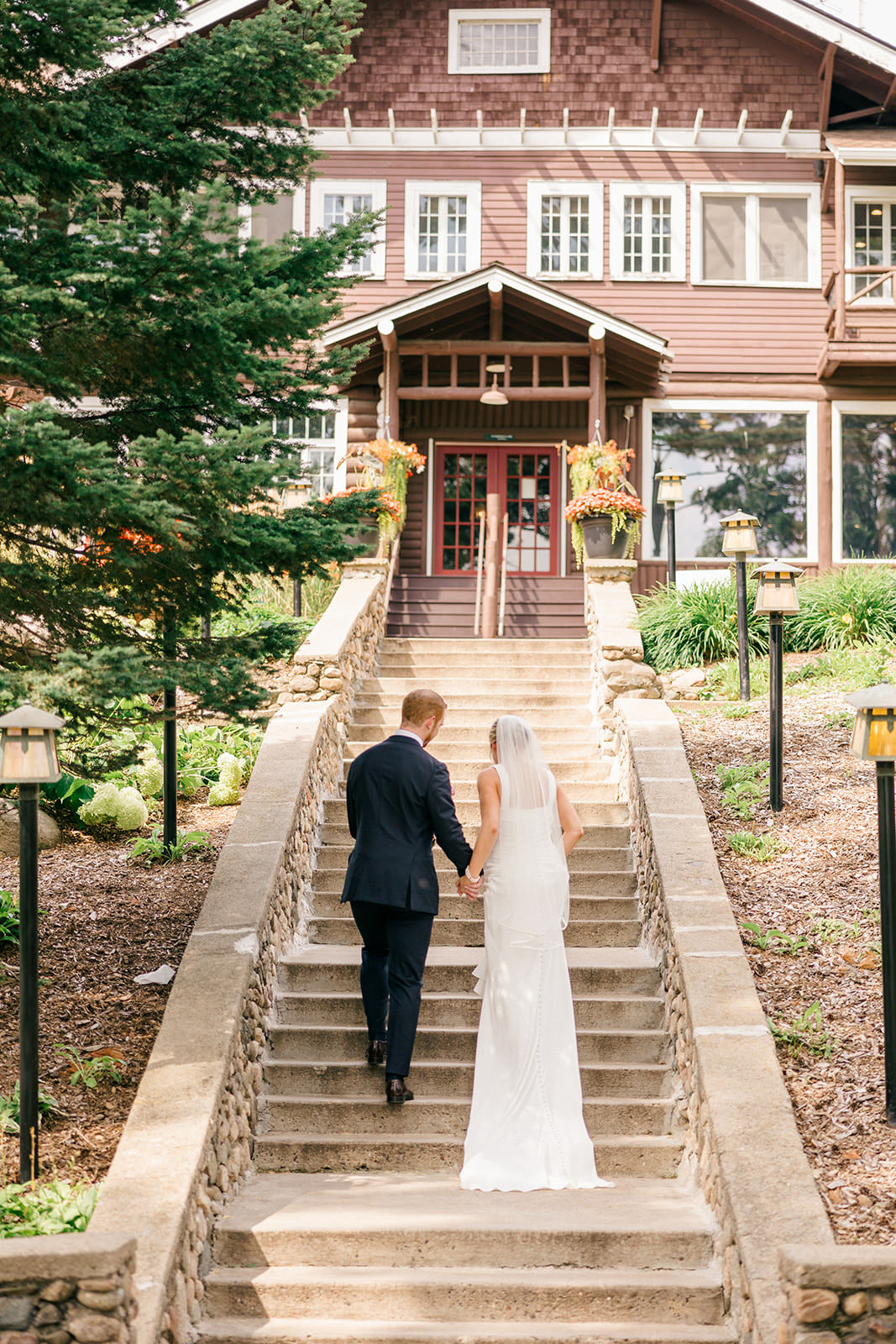 Couple ascending the Grand Staircase together — Grand View Lodge — Tim Larsen Photography, Brainerd Lakes MN