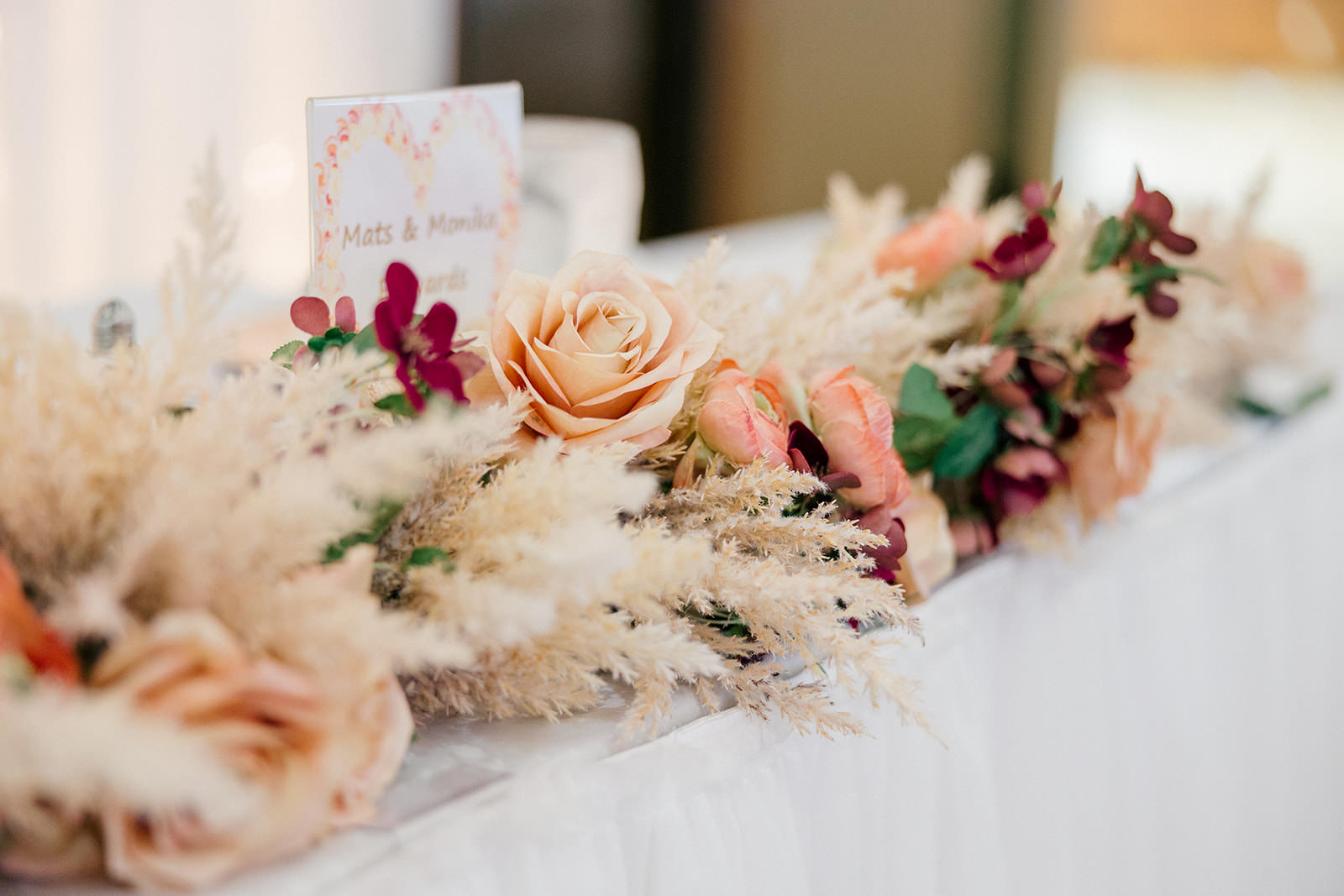 Head table centerpiece with roses and pampas grass in warm tones — Grand View Lodge reception — Tim Larsen Photography, Brainerd Lakes MN