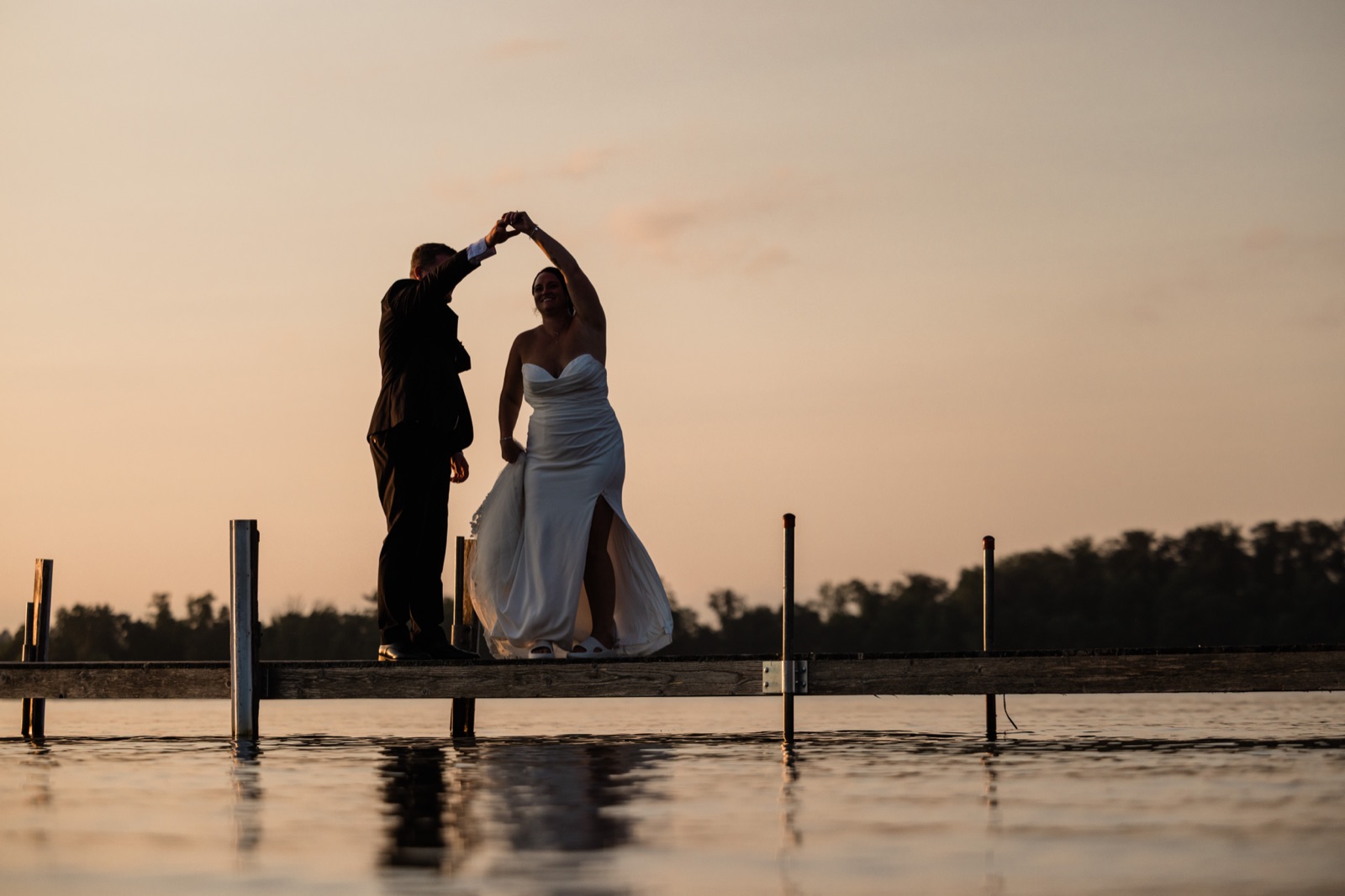 Silhouetted couple twirling on the dock at dusk over Gull Lake — Madden's on Gull Lake — Tim Larsen Photography, Brainerd Lakes MN