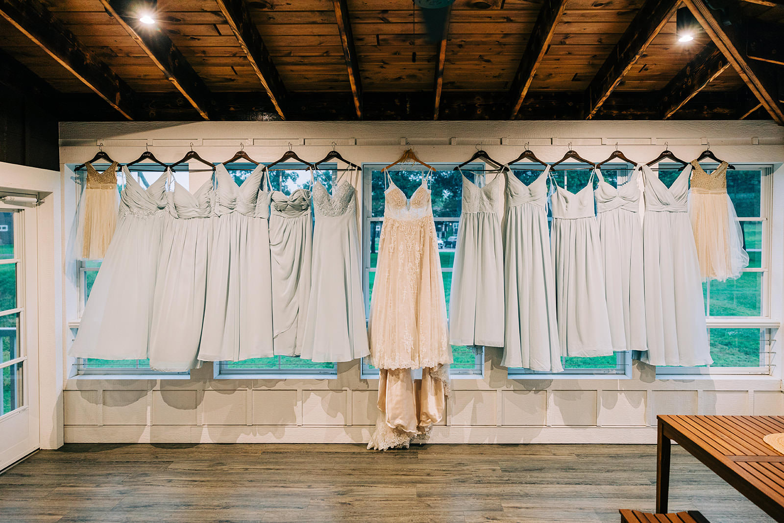 Bridesmaids dresses and wedding gown hanging in the window — getting ready at Grand View Lodge — Tim Larsen Photography, Brainerd Lakes MN