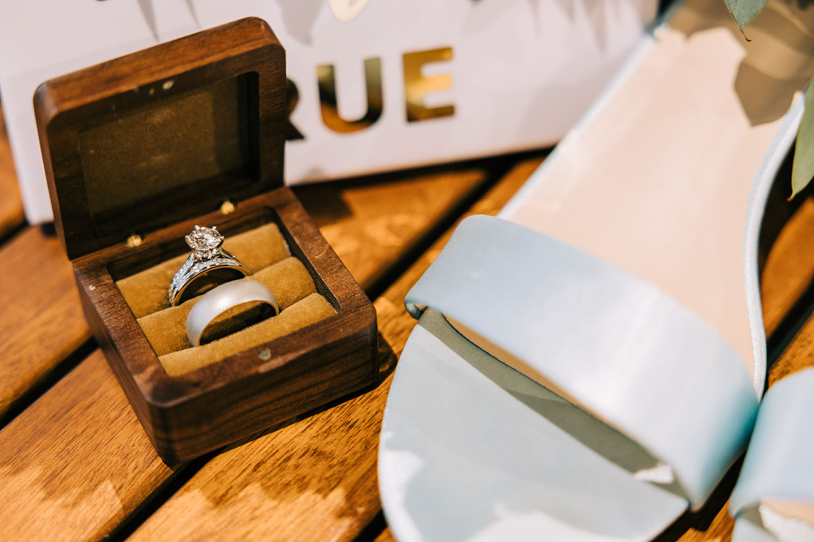 Wedding rings in wooden box with white bridal shoes — detail flat lay — Tim Larsen Photography, Brainerd Lakes MN