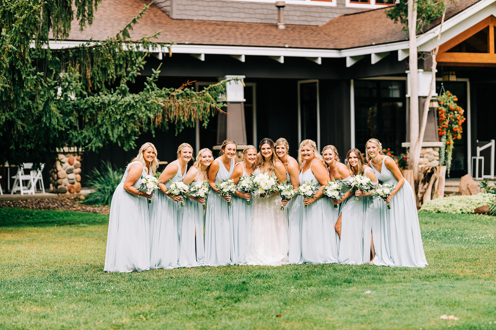 Full bridal party on the lawn at Grand View Lodge — sage and light blue dresses — Tim Larsen Photography, Brainerd Lakes MN