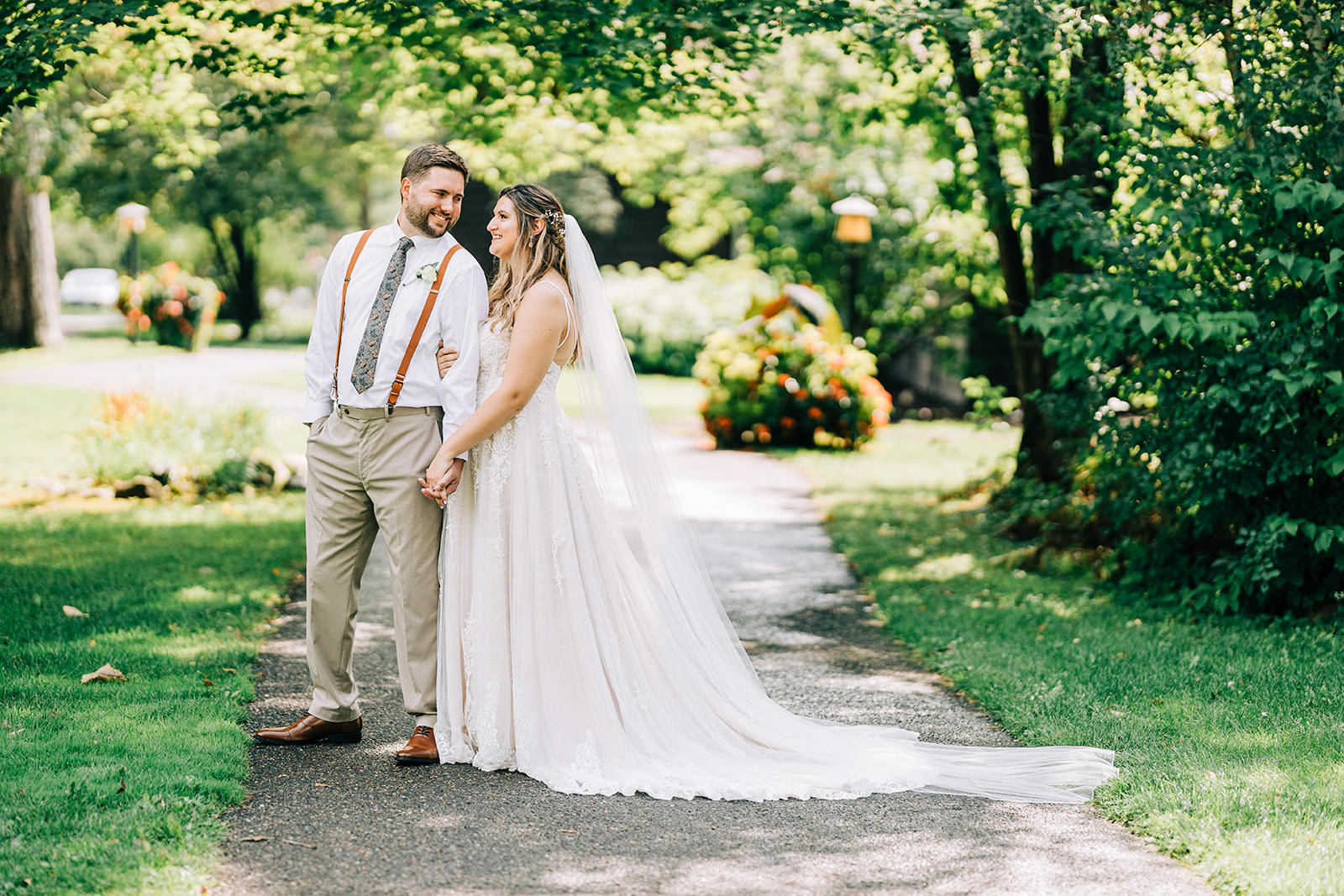 Shannon and Jon walking hand in hand on the garden path — Grand View Lodge — Tim Larsen Photography, Brainerd Lakes MN