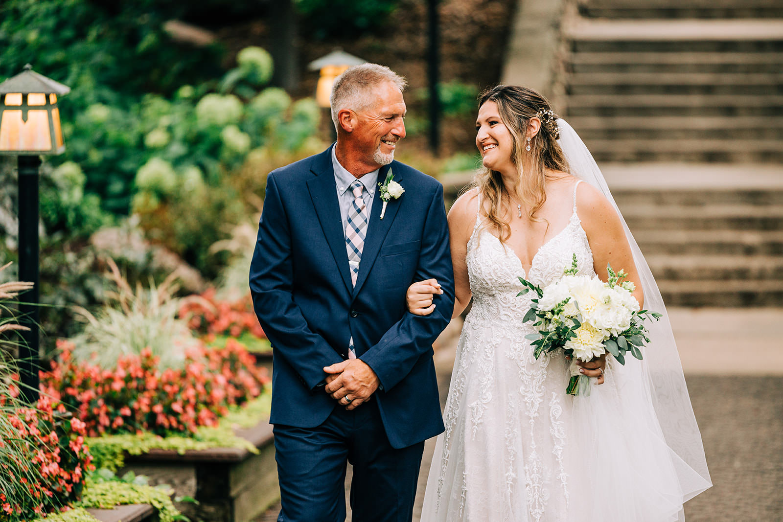 Shannon and her father walking down the Grand Staircase — begonias and lanterns lining the aisle — Tim Larsen Photography, Brainerd Lakes MN