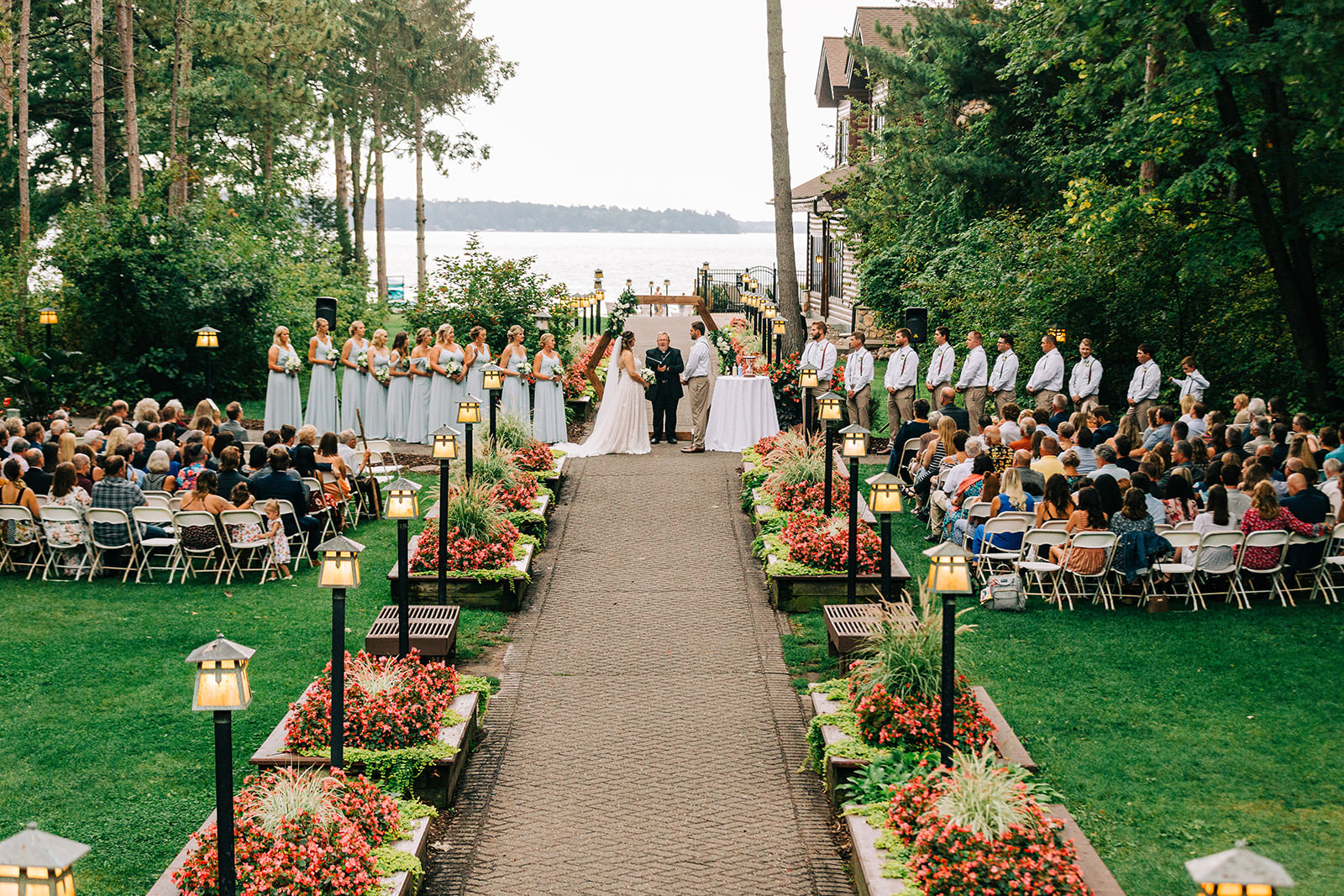 Grand Staircase ceremony — full view with guests, begonias, lanterns, and Gull Lake behind — Tim Larsen Photography, Brainerd Lakes MN