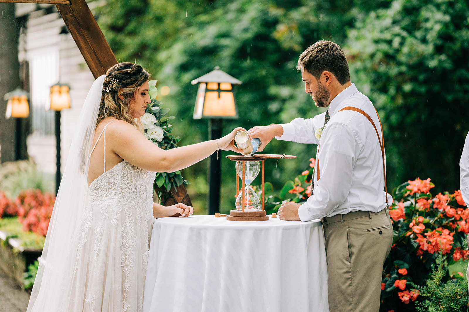 Hourglass unity ceremony — Shannon and Jon pouring sand at the altar — Tim Larsen Photography, Brainerd Lakes MN