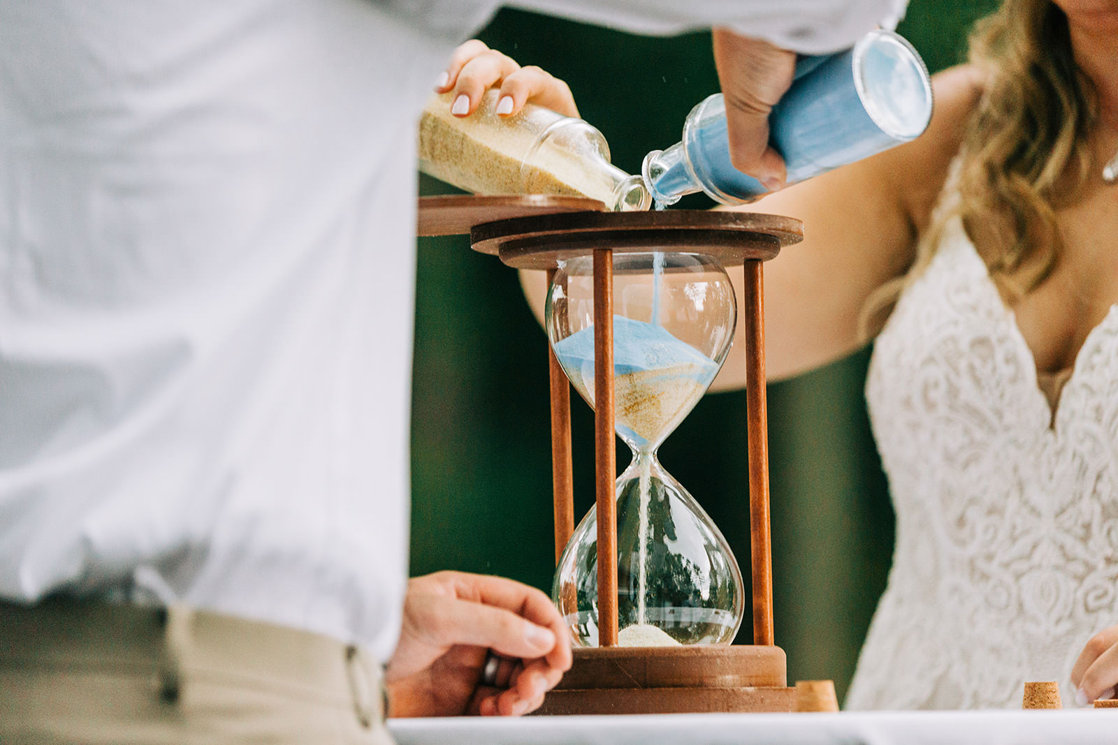 Hourglass sand ceremony detail — colored sand blending together — Tim Larsen Photography, Brainerd Lakes MN