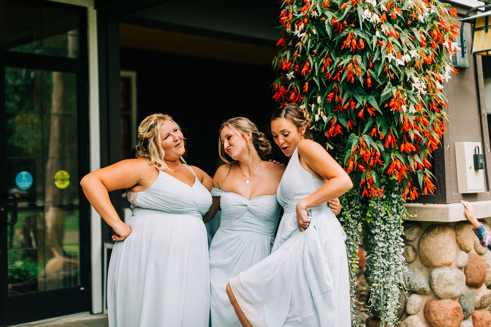 Bridesmaids laughing together by the hanging flowers at Grand View Lodge — Tim Larsen Photography, Brainerd Lakes MN