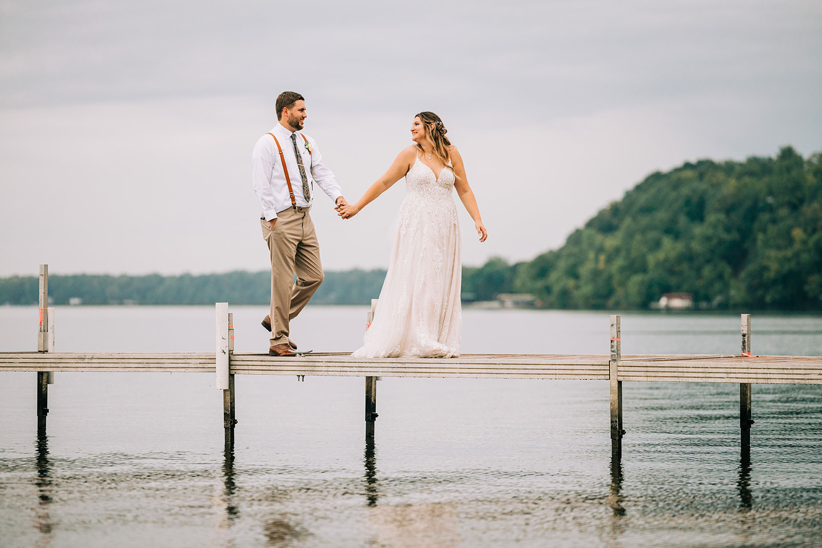 Shannon and Jon walking hand in hand on the Gull Lake dock — Tim Larsen Photography, Brainerd Lakes MN
