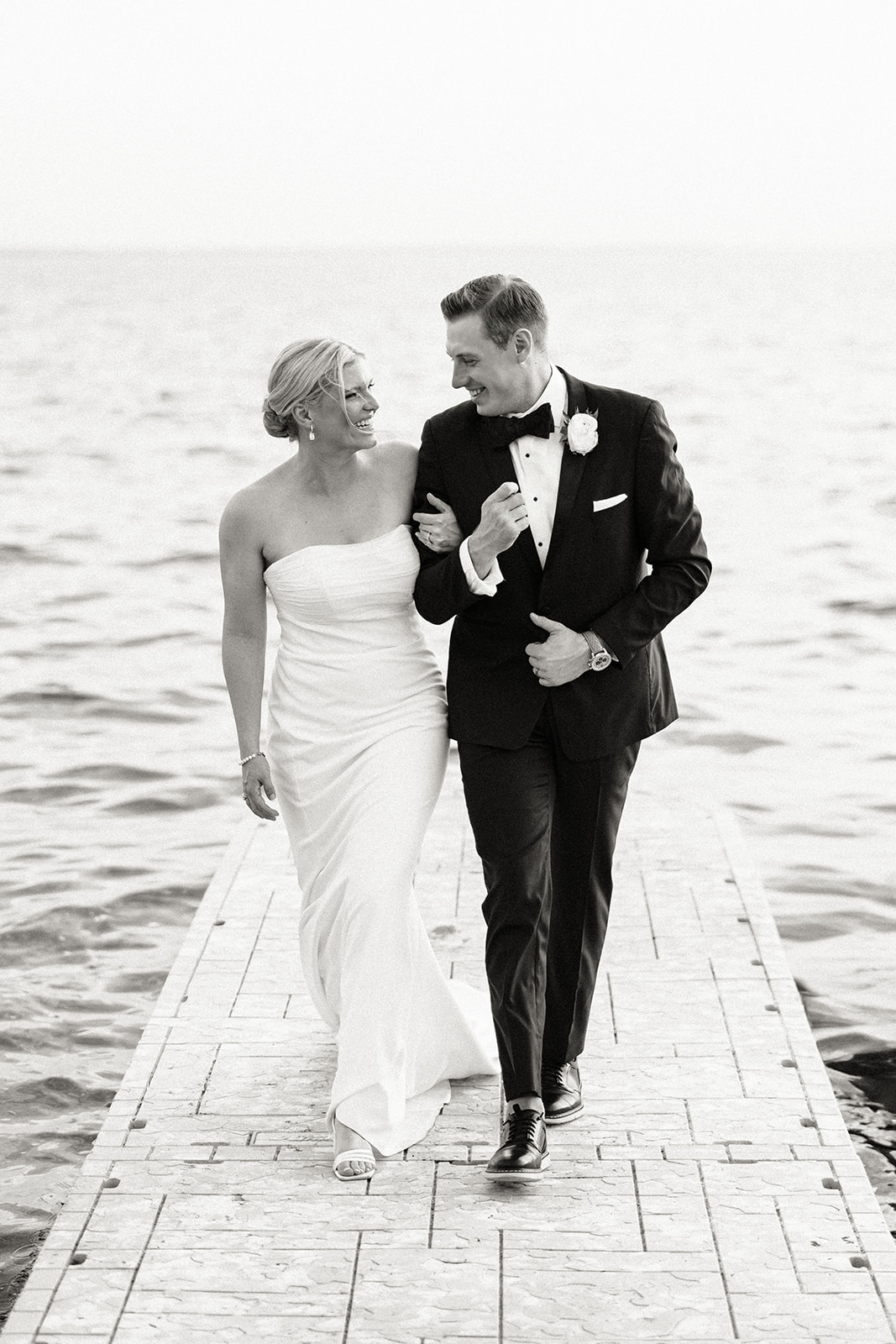 Couple walking arm in arm on a dock over the lake — Tim Larsen Photography, Brainerd Lakes MN