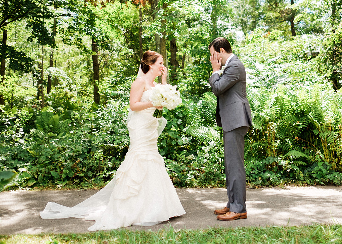 Groom wiping tears during the first look in the woods — Tim Larsen Photography, Brainerd Lakes MN