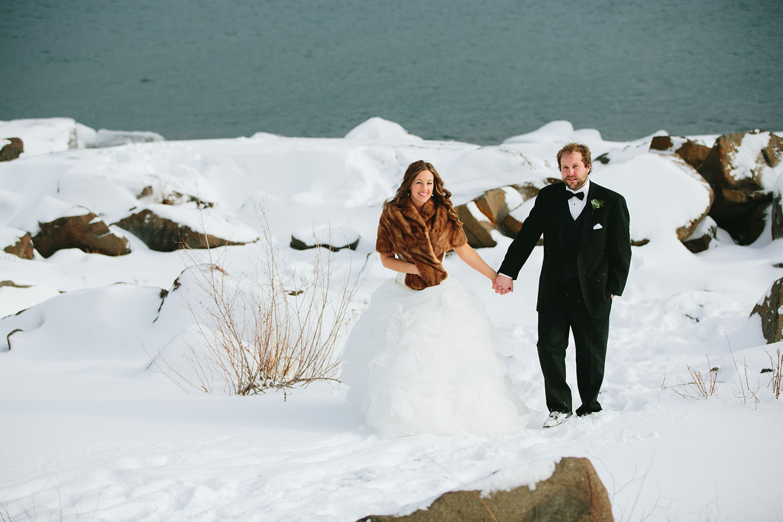 Winter wedding portrait on the snowy Lake Superior shoreline — bride in fur stole — Tim Larsen Photography, Brainerd Lakes MN