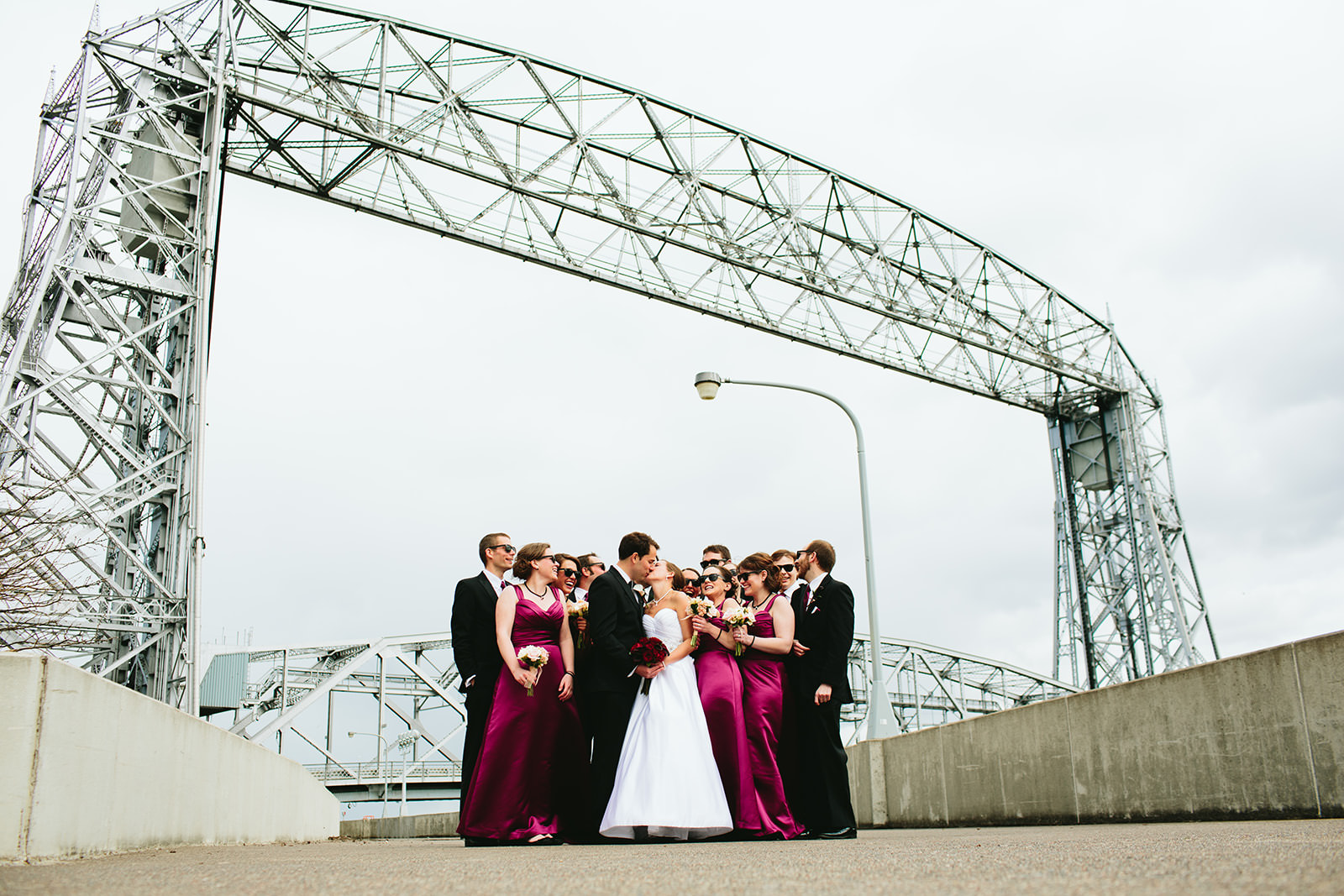Wedding party toasting under the Aerial Lift Bridge in Duluth — Tim Larsen Photography, Brainerd Lakes MN