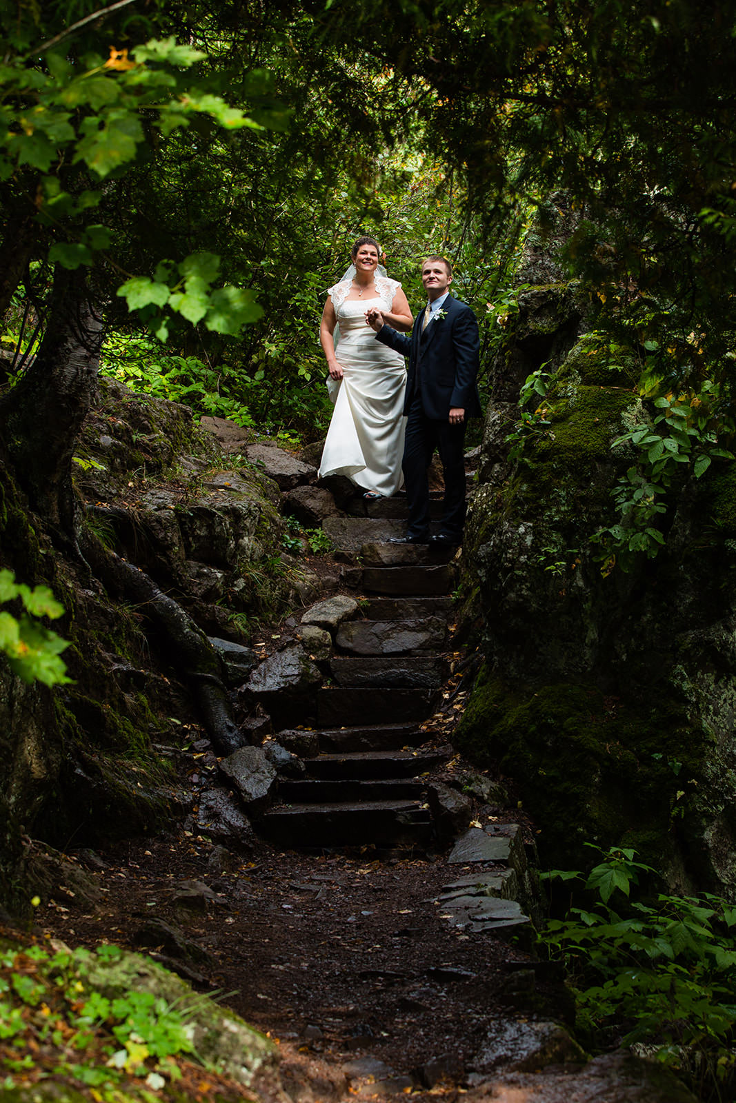 Couple on stone steps through lush green forest — North Shore portrait — Tim Larsen Photography, Brainerd Lakes MN