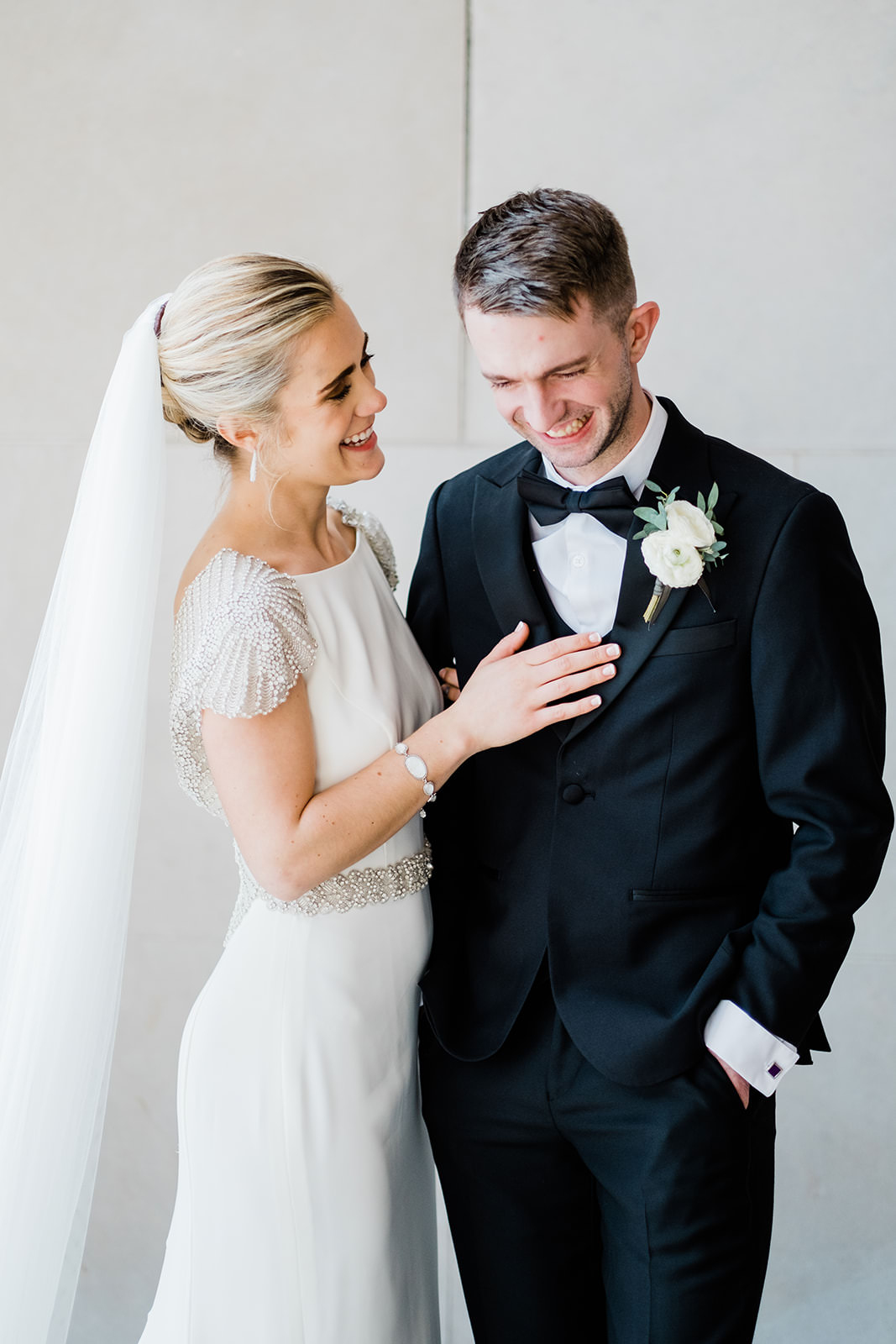 Bride and groom laughing together — beaded cap sleeve dress and black tux — Tim Larsen Photography, Brainerd Lakes MN