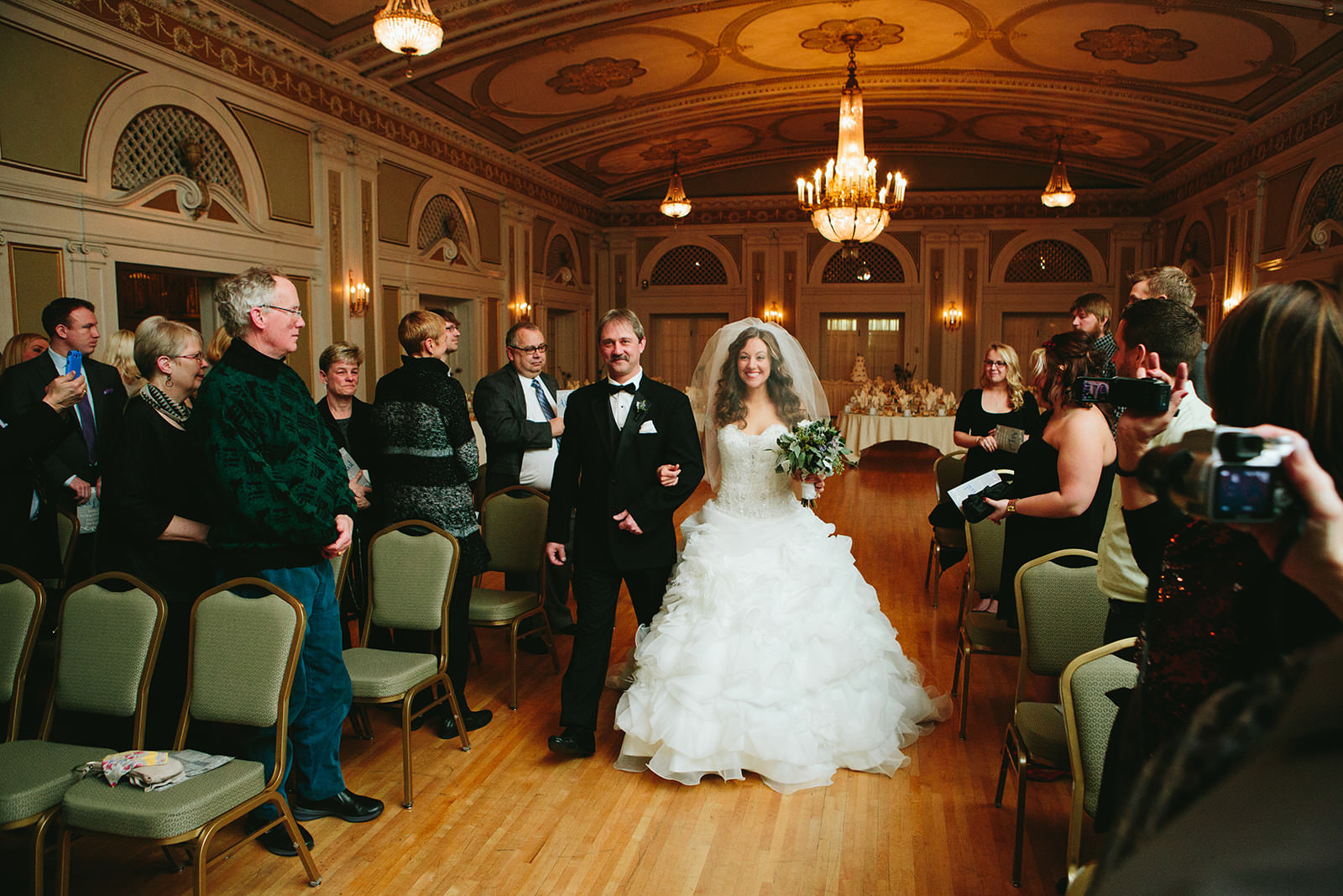 Couple walking down the aisle in an ornate historic ballroom — Duluth — Tim Larsen Photography, Brainerd Lakes MN