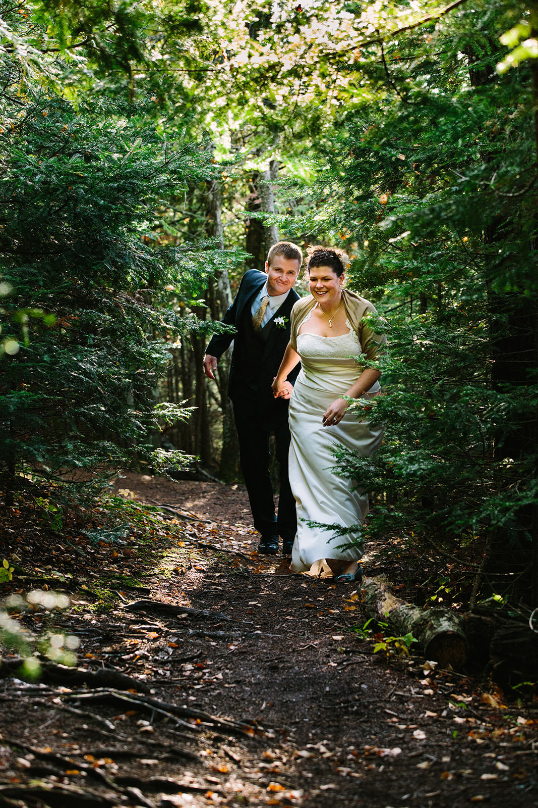 Couple walking through the forest on a North Shore trail — summer wedding — Tim Larsen Photography, Brainerd Lakes MN