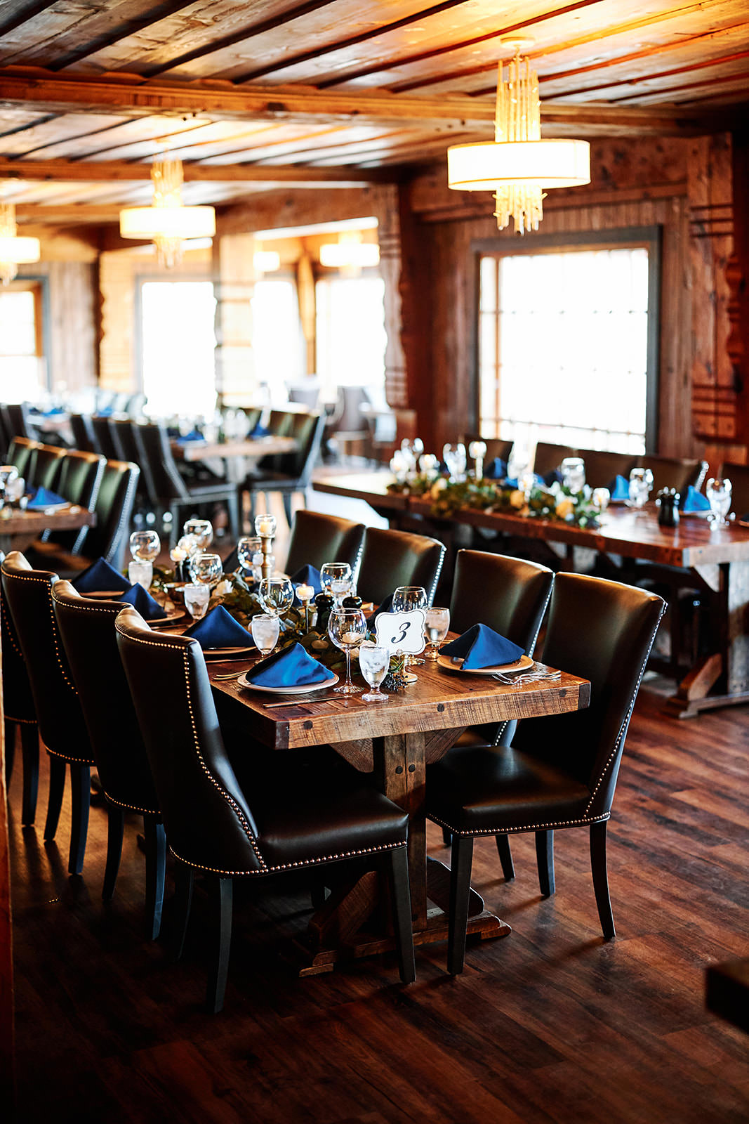 Lodge reception room with rustic wood tables and blue napkins — North Shore — Tim Larsen Photography, Brainerd Lakes MN