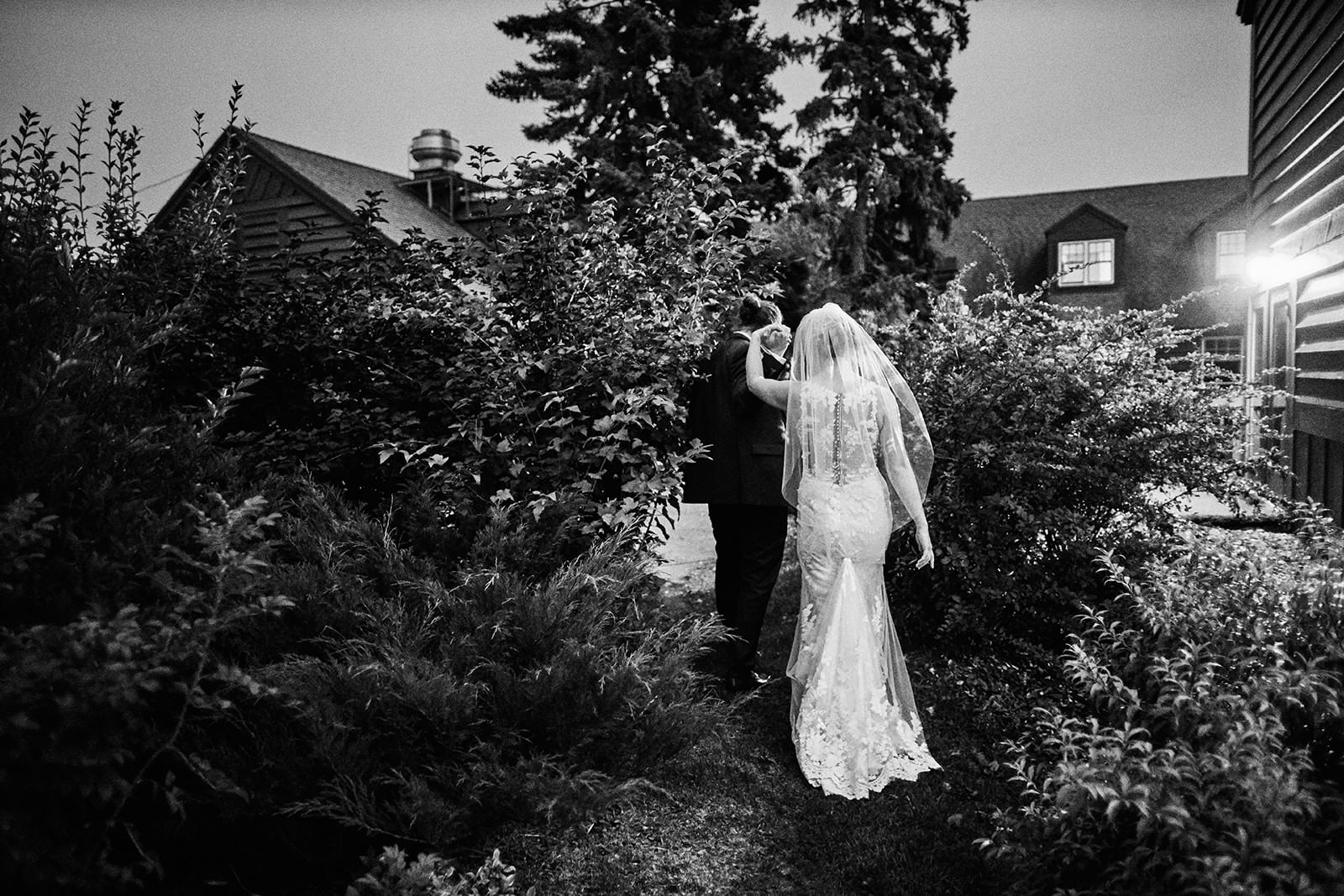 Couple walking through the garden at night in black and white — North Shore lodge — Tim Larsen Photography, Brainerd Lakes MN