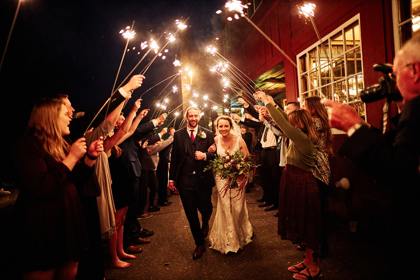 Sparkler send-off outside a North Shore lodge — guests lining the path — Tim Larsen Photography, Brainerd Lakes MN